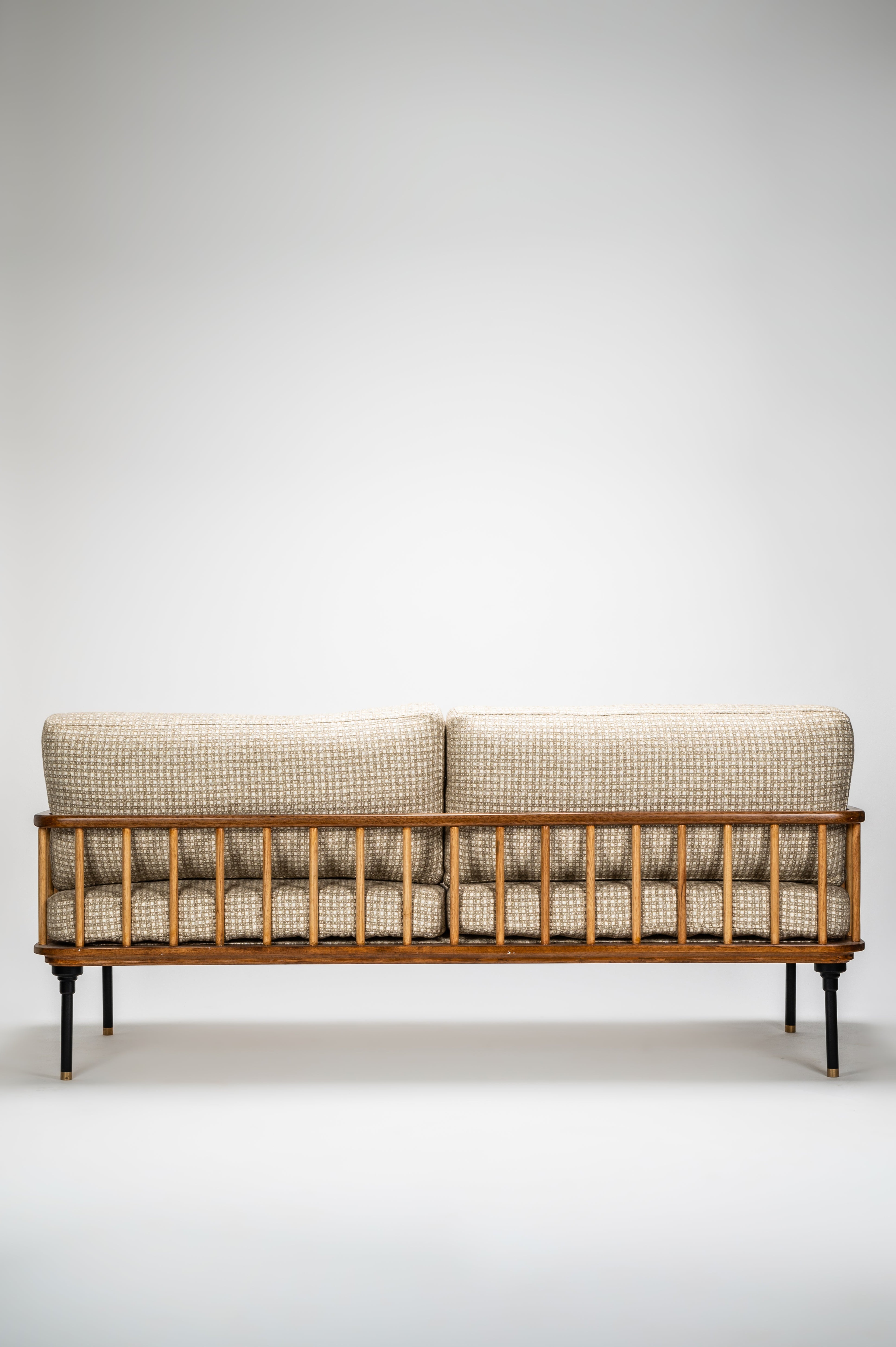 Wooden sofa with checkered cushions on a white background
