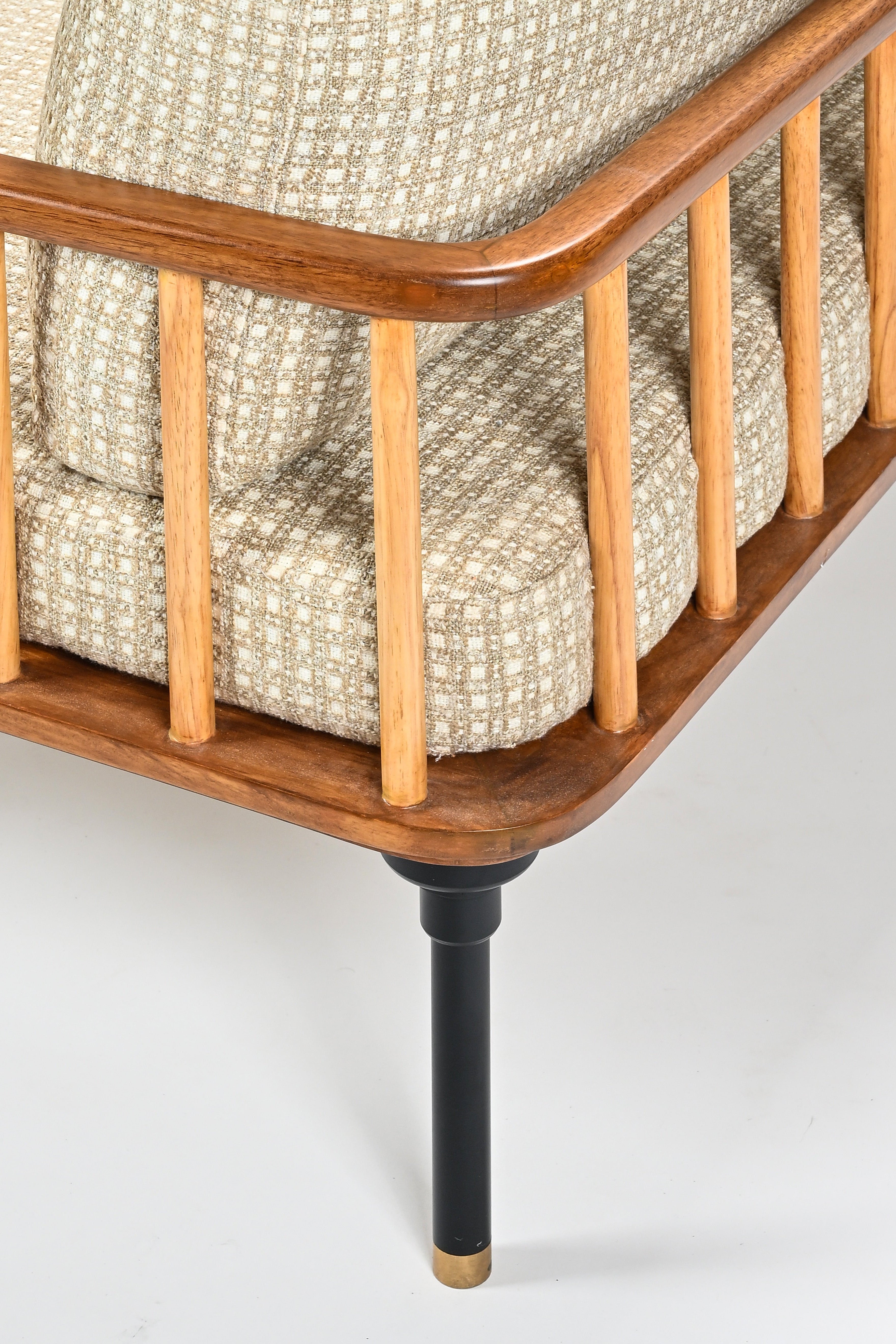 Wooden crib with textured mattress on a white background