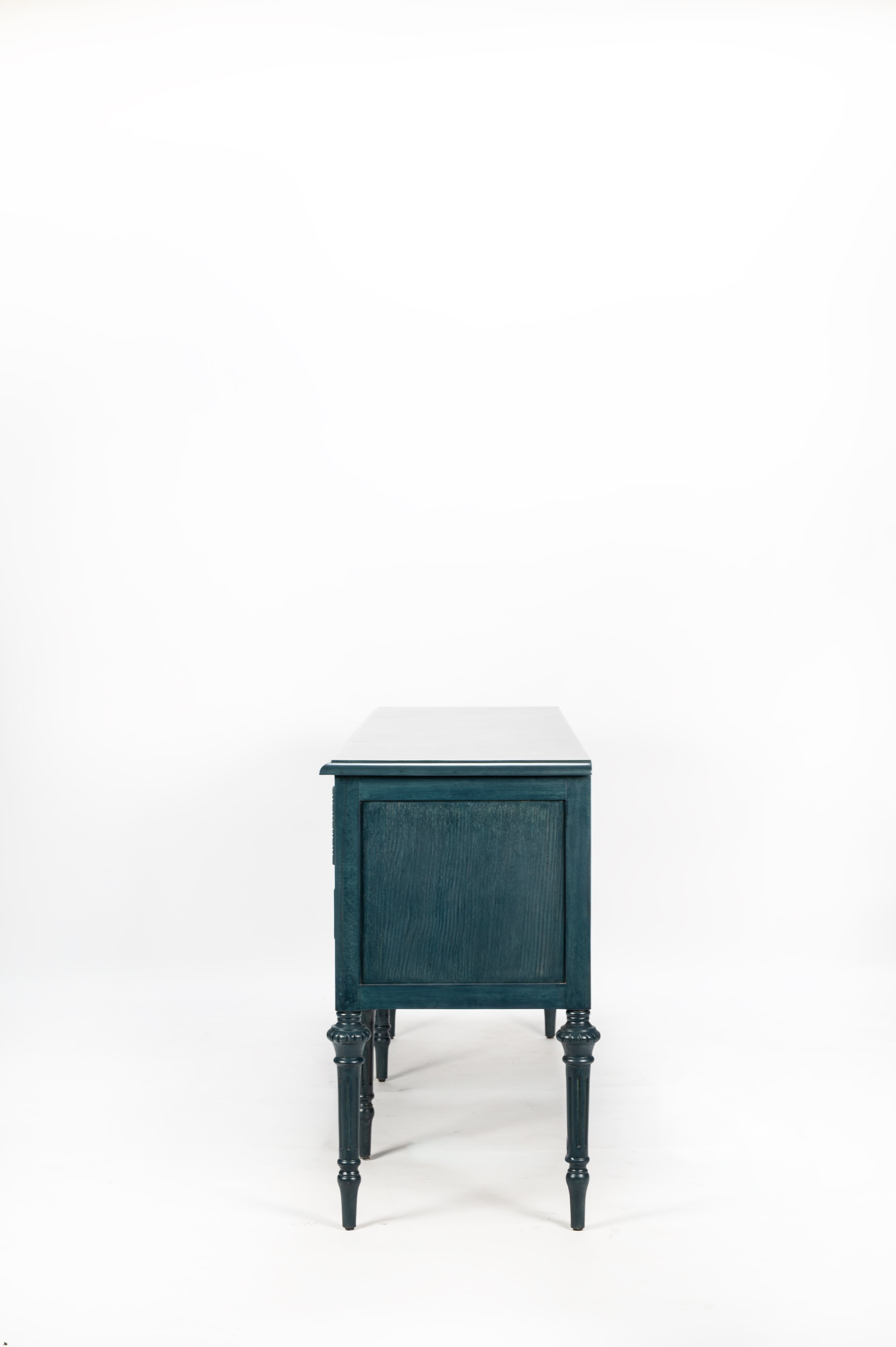 Teal side table with white top on a white background