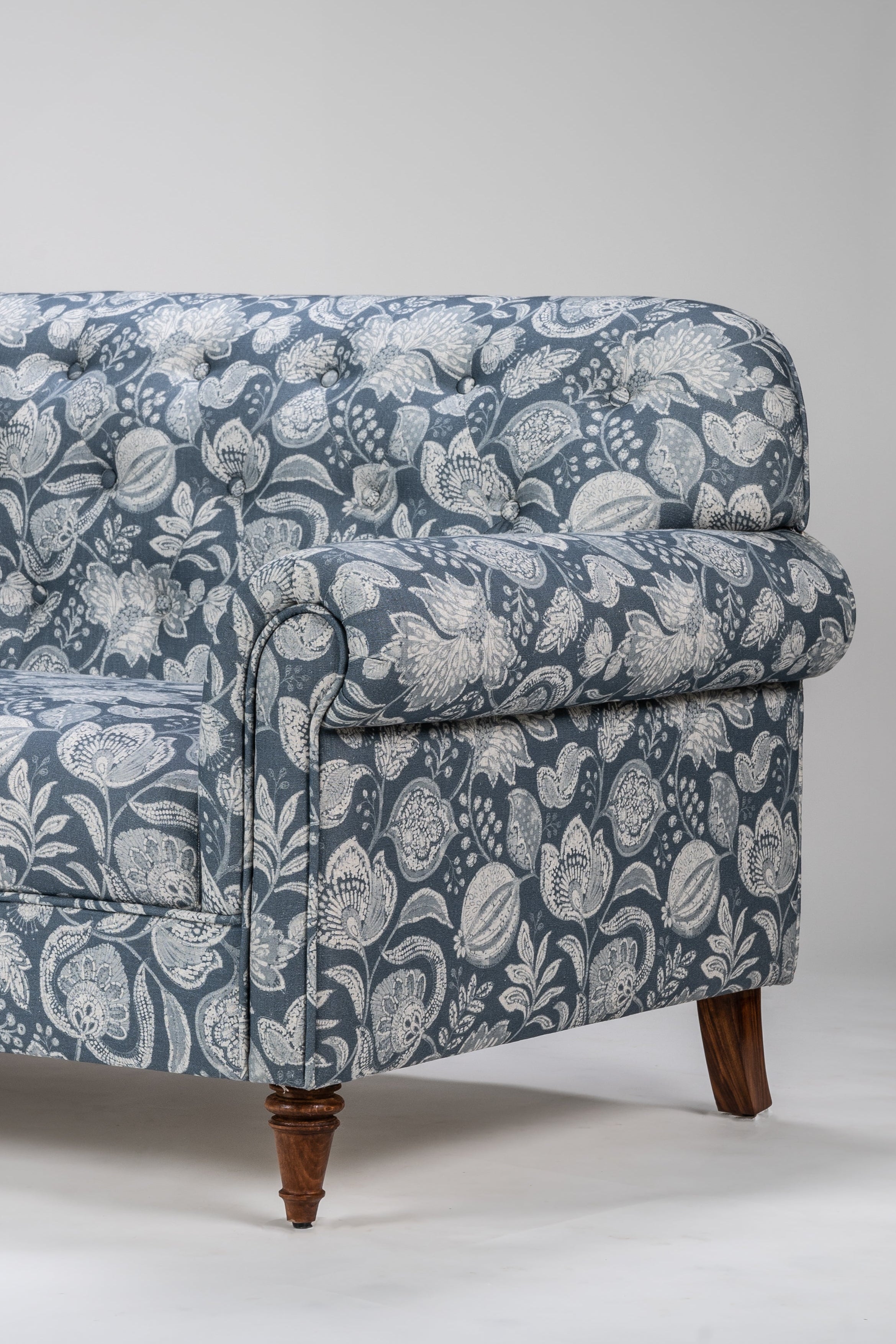 Blue floral-patterned sofa on a white background