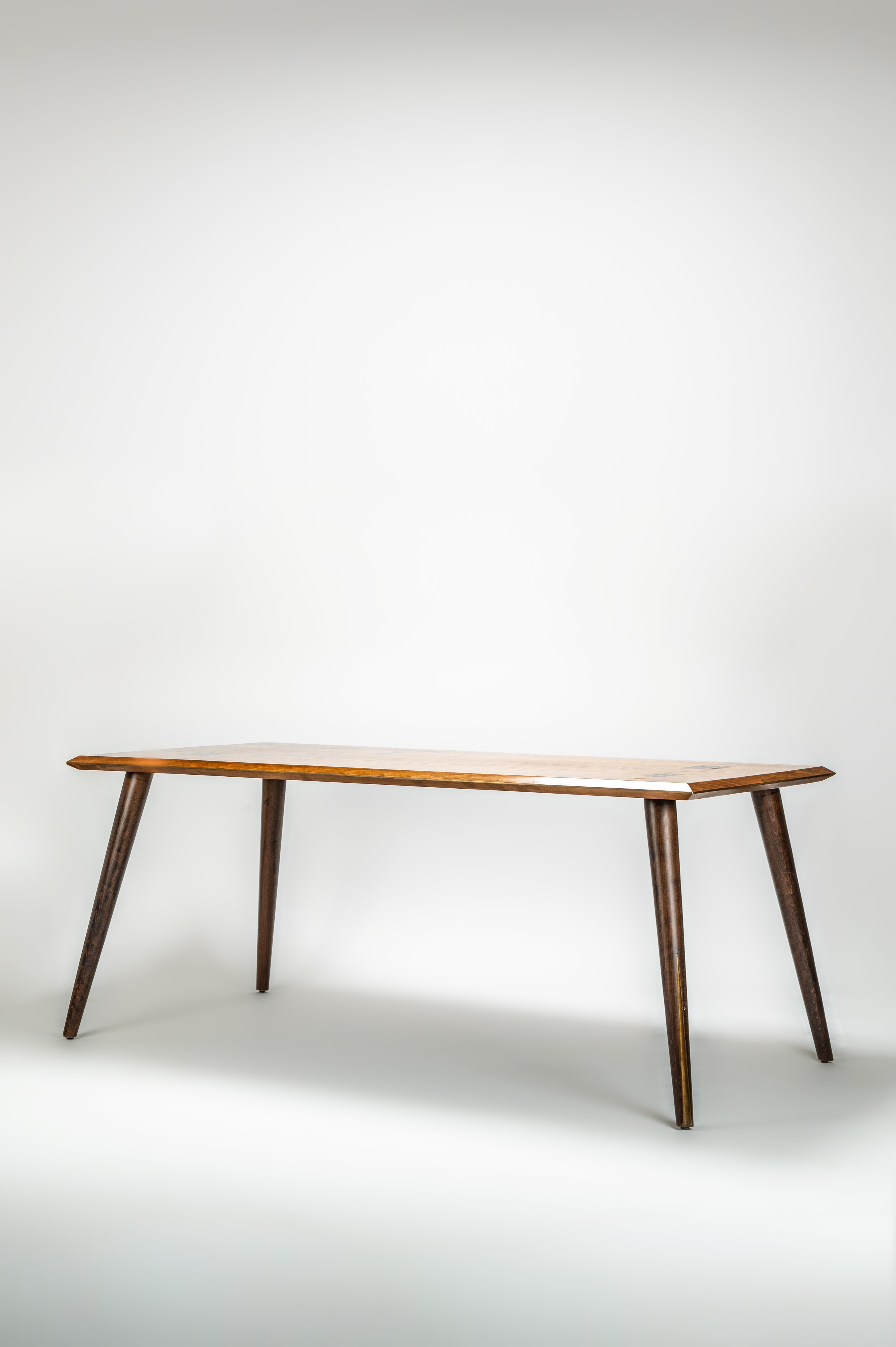 Wooden table with four legs on a white background
