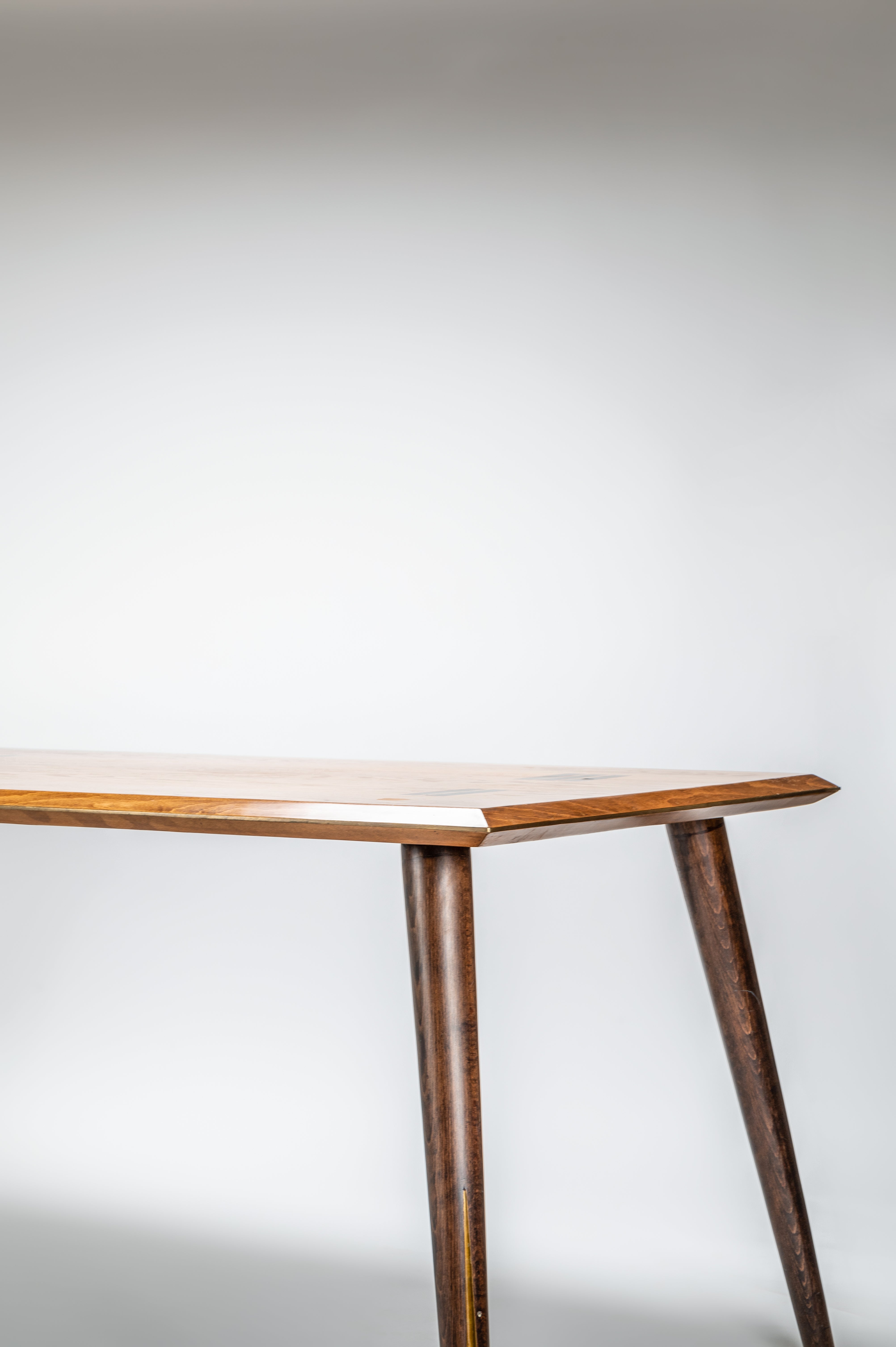 Wooden table with a minimalist design on a plain background