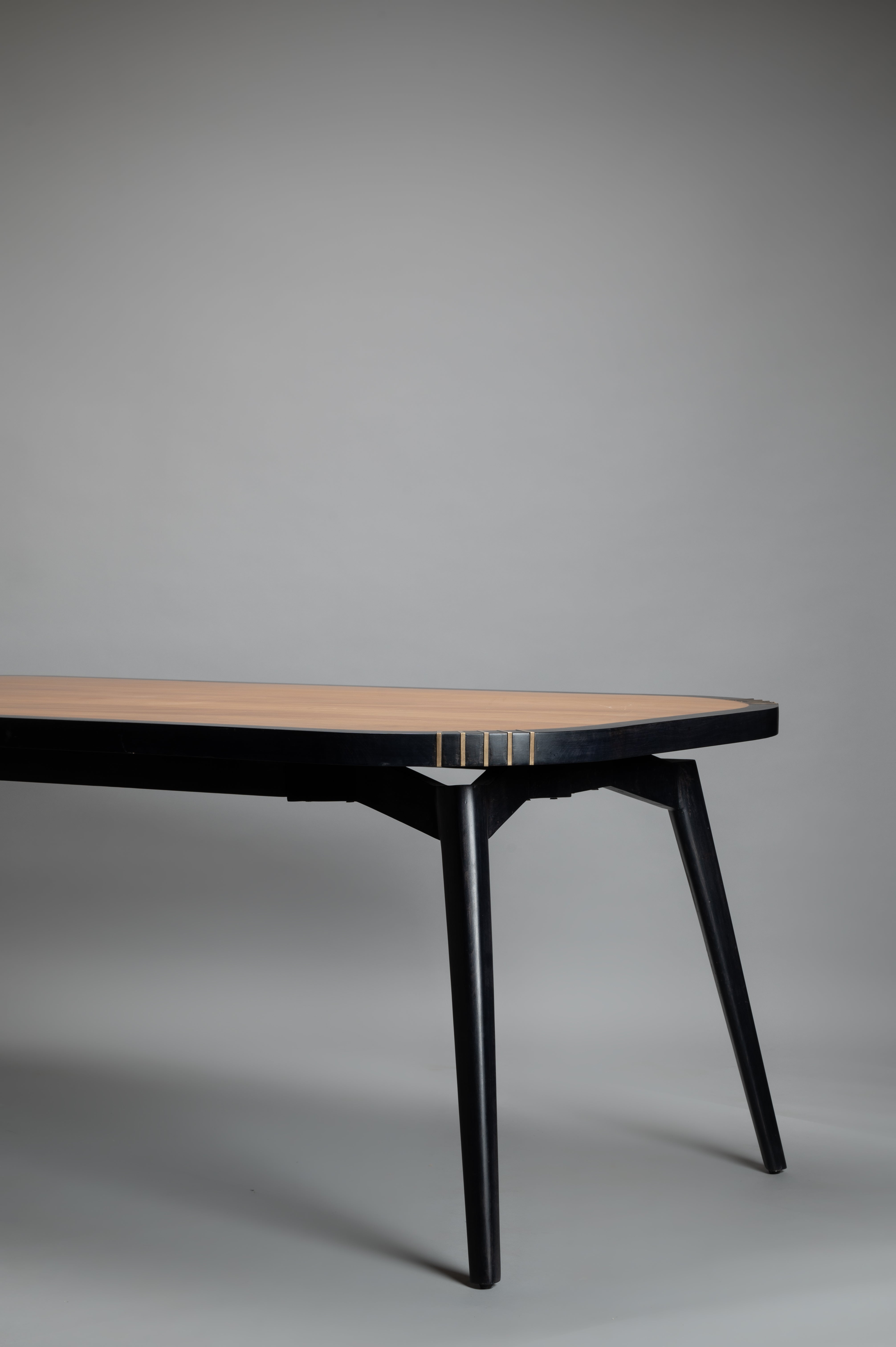 Wooden table with black base on a gray background
