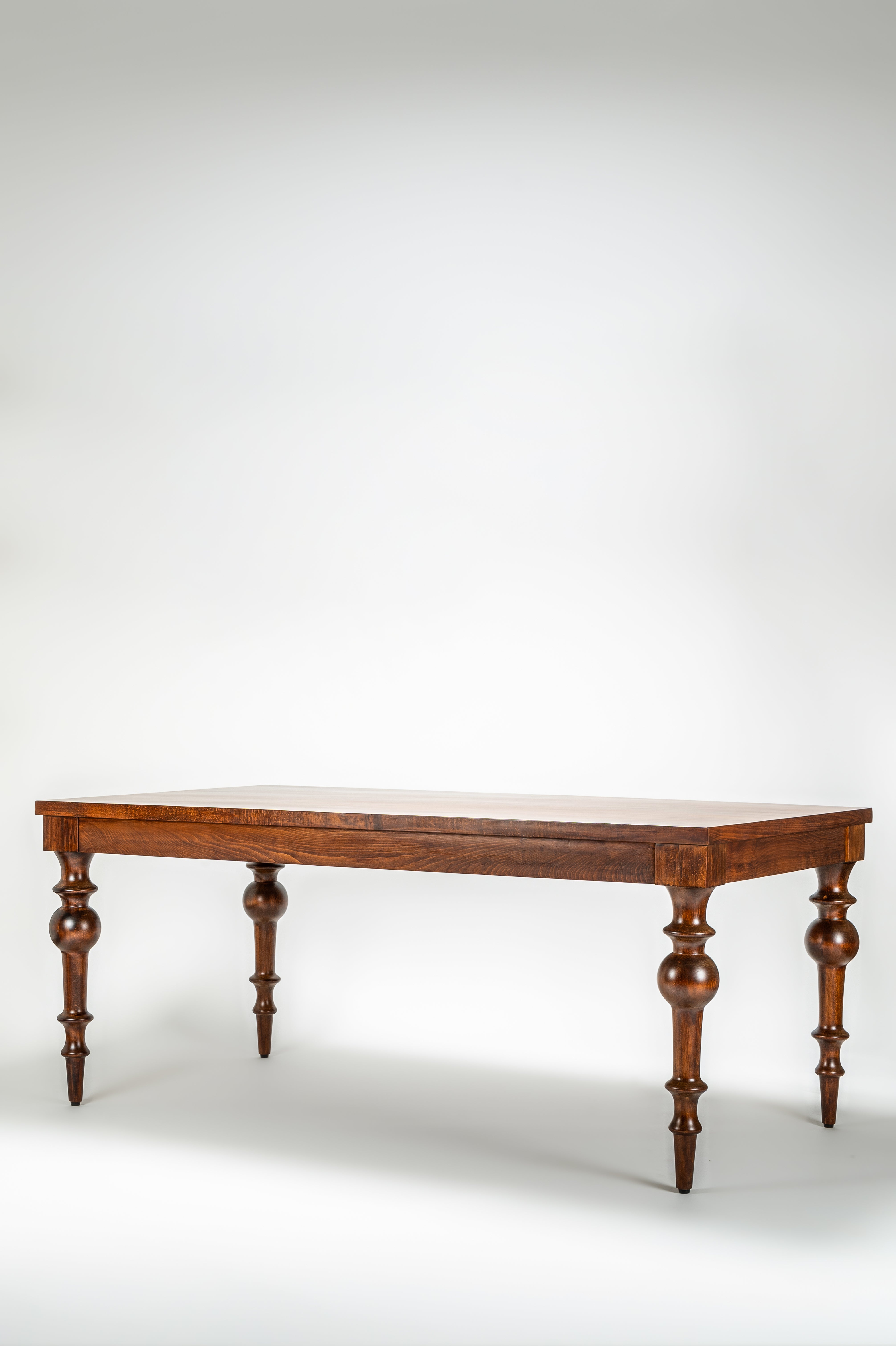 Wooden table with a white surface on a plain background