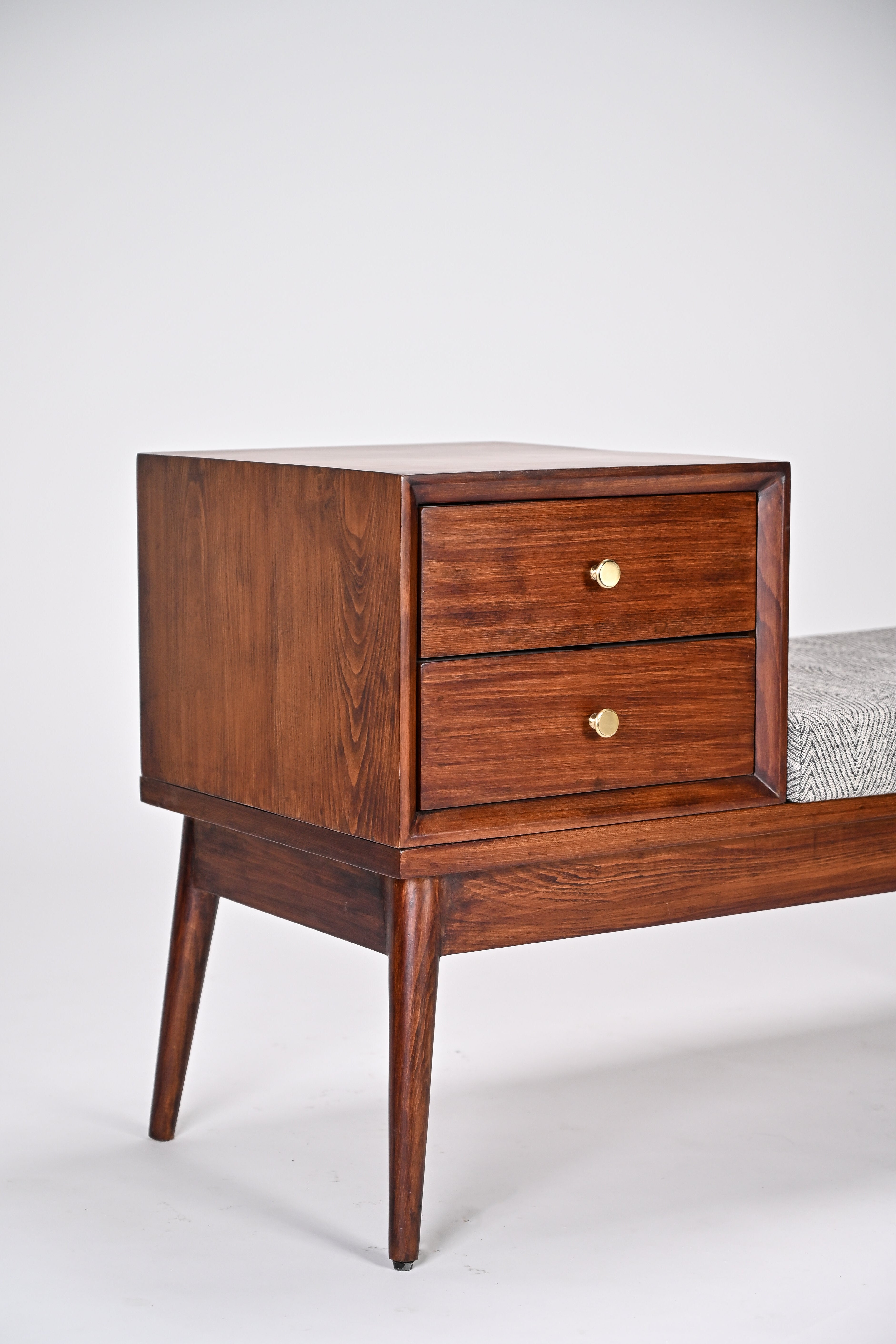 Wooden nightstand with two drawers on a white background