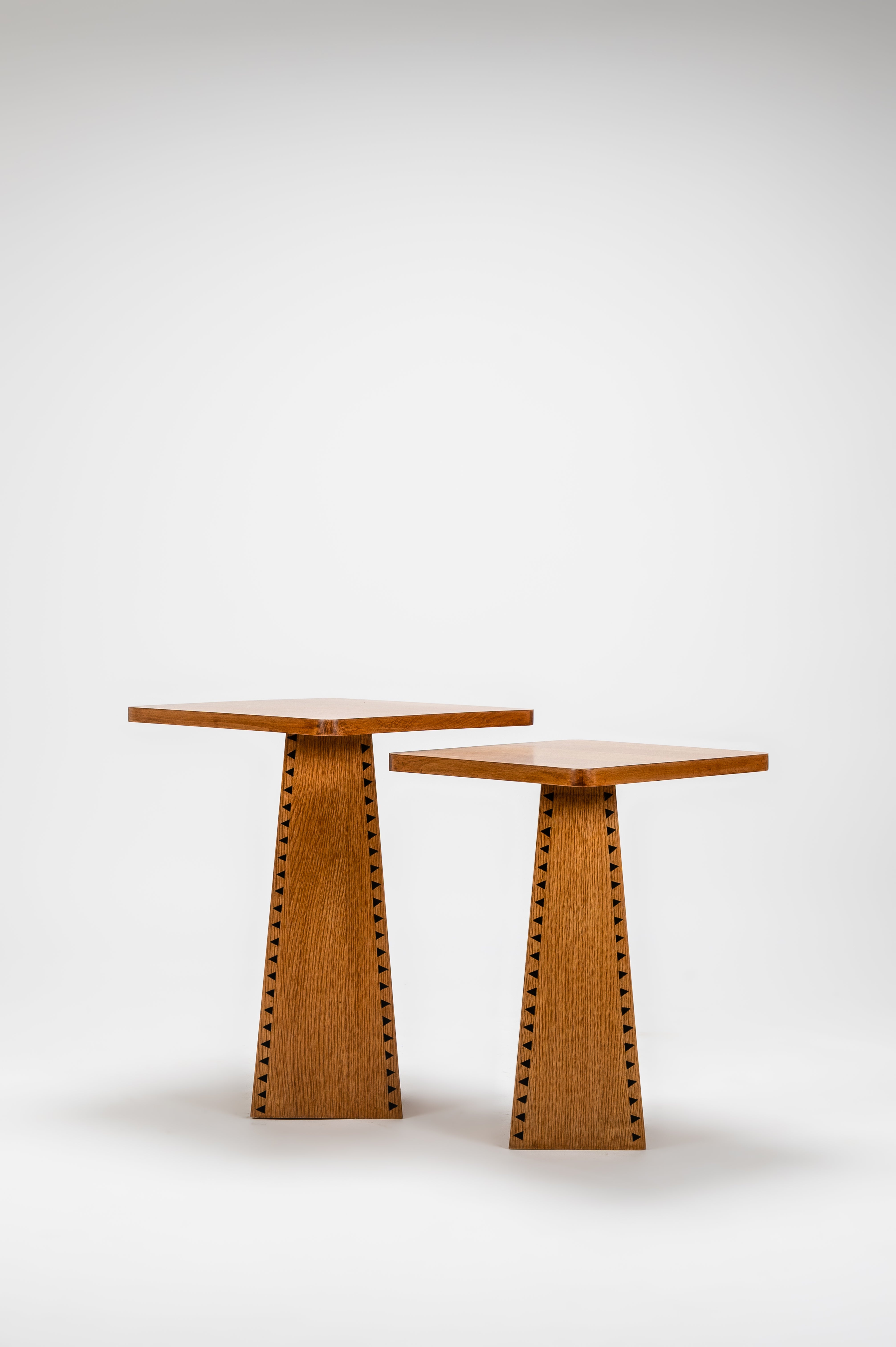 Two wooden side tables with unique designs on a white background