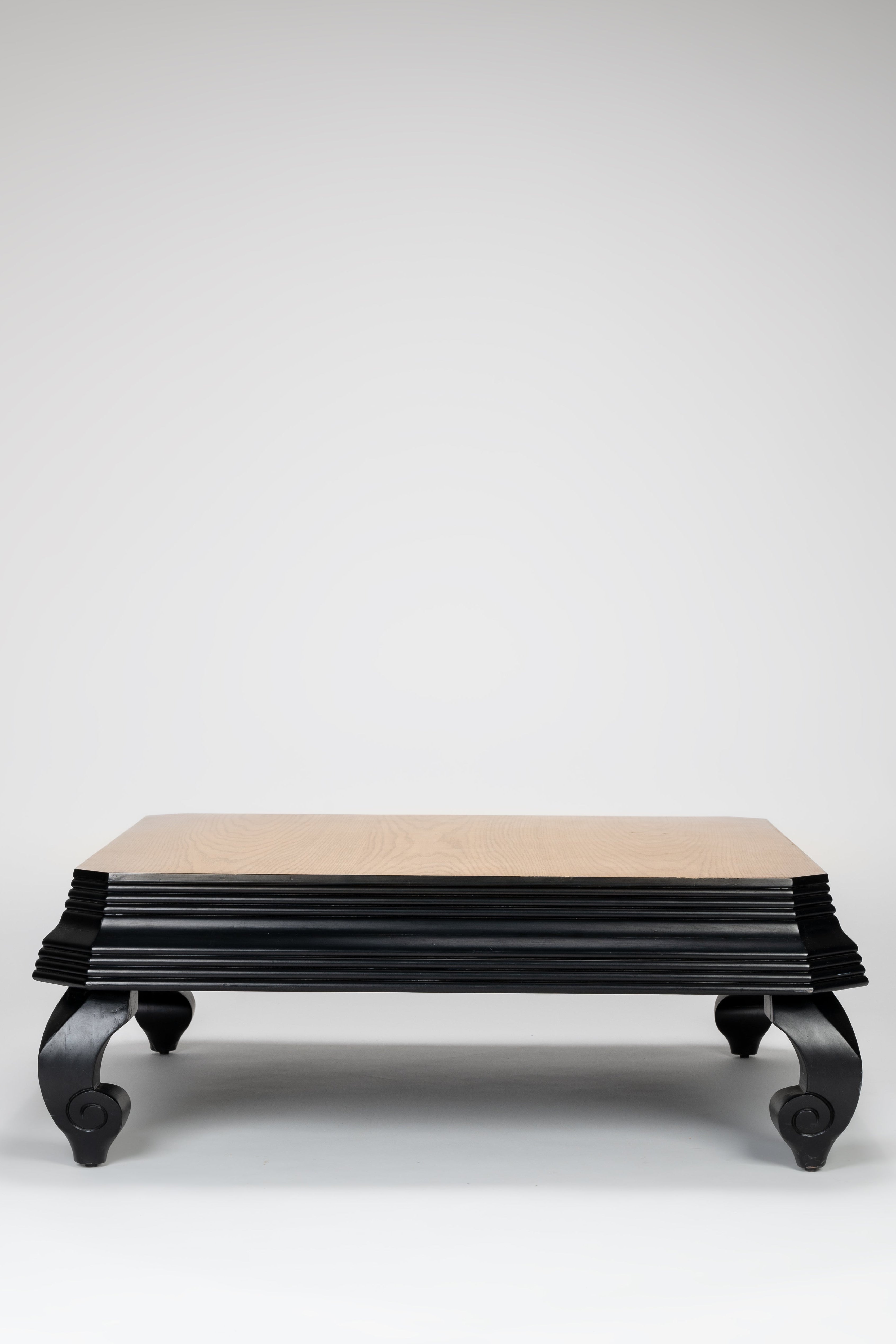 Decorative bench with black base and beige top on a white background
