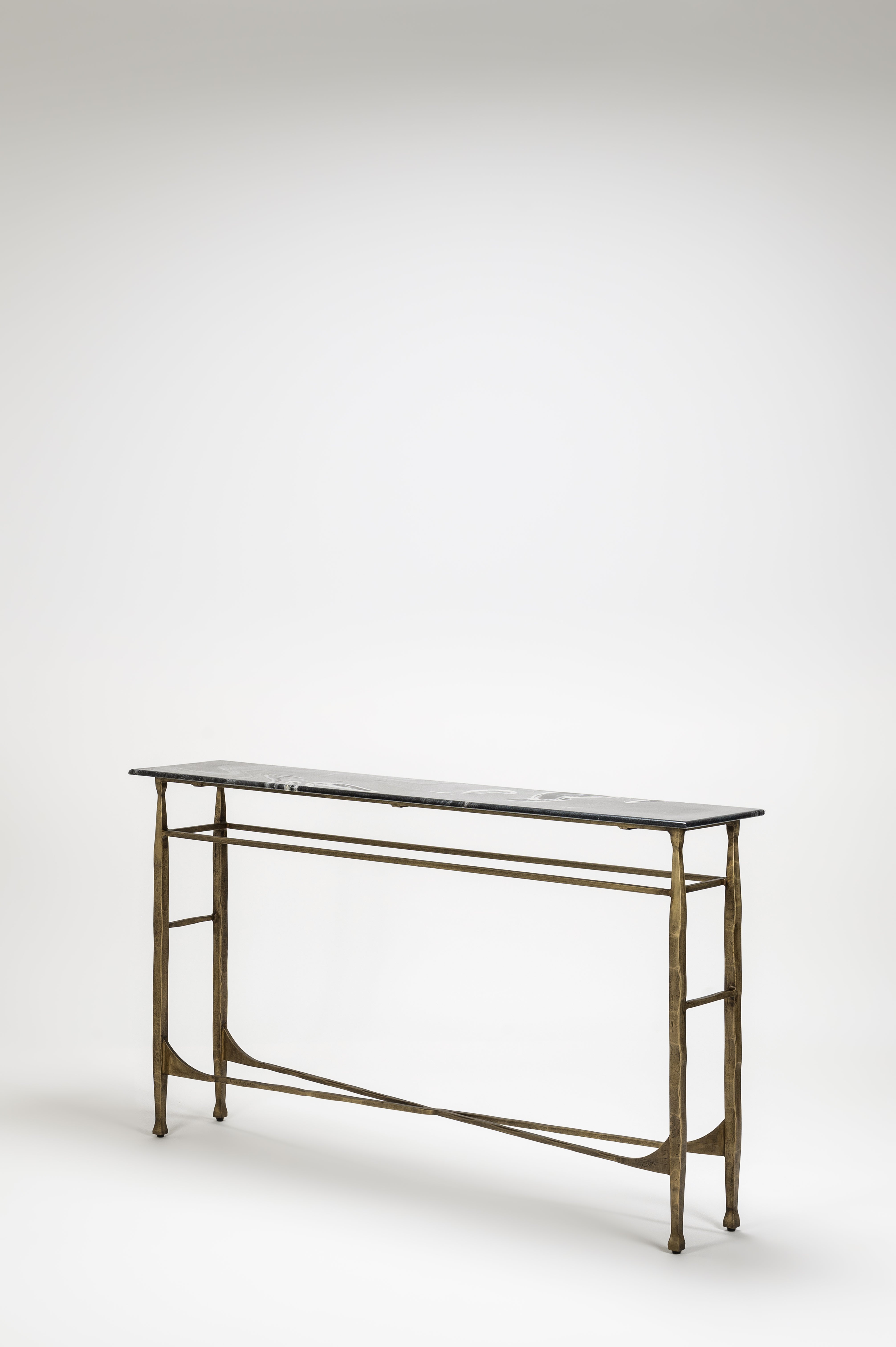 Console table with a black top and bronze base on a white background