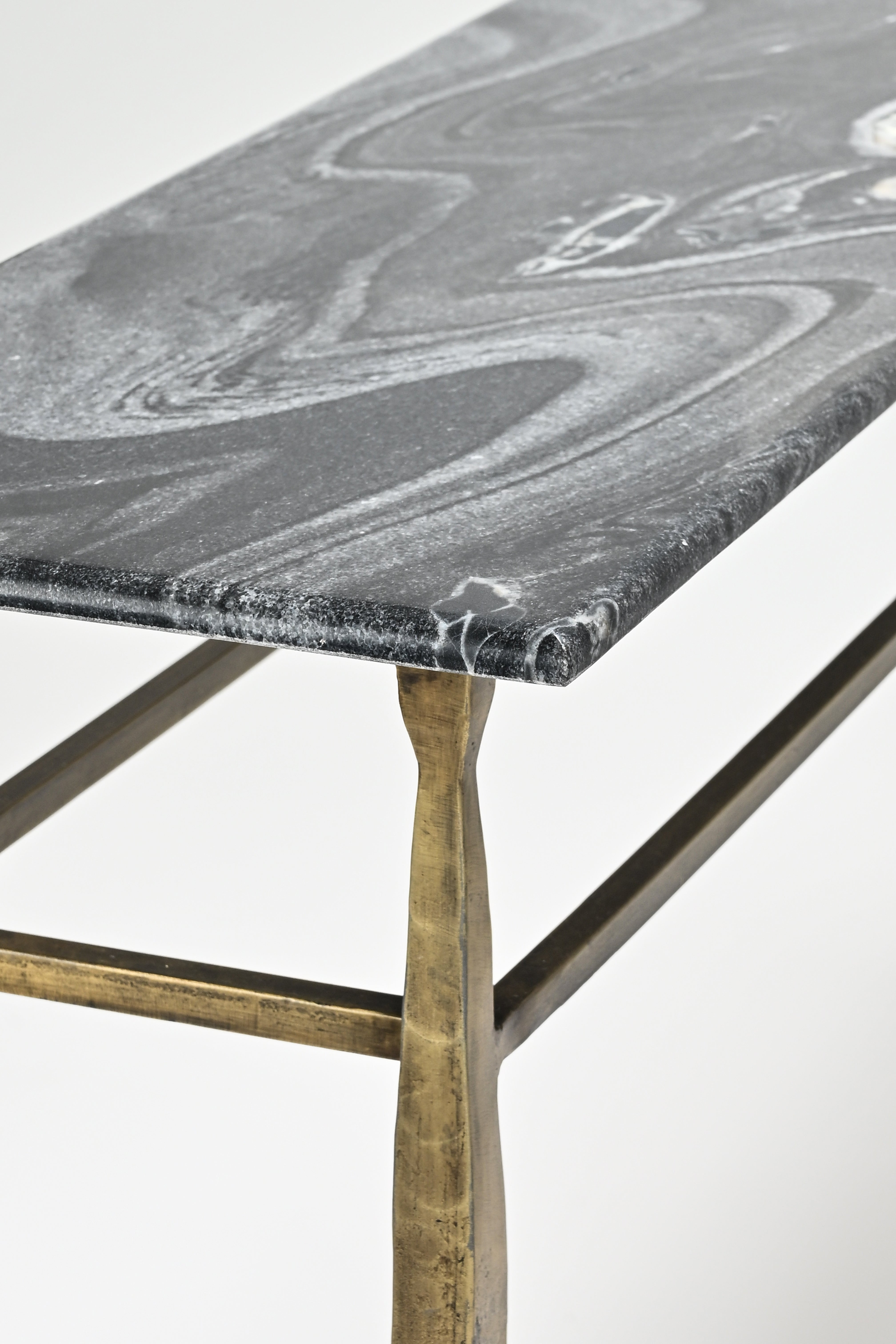 Marble-top table with bronze legs on a white background