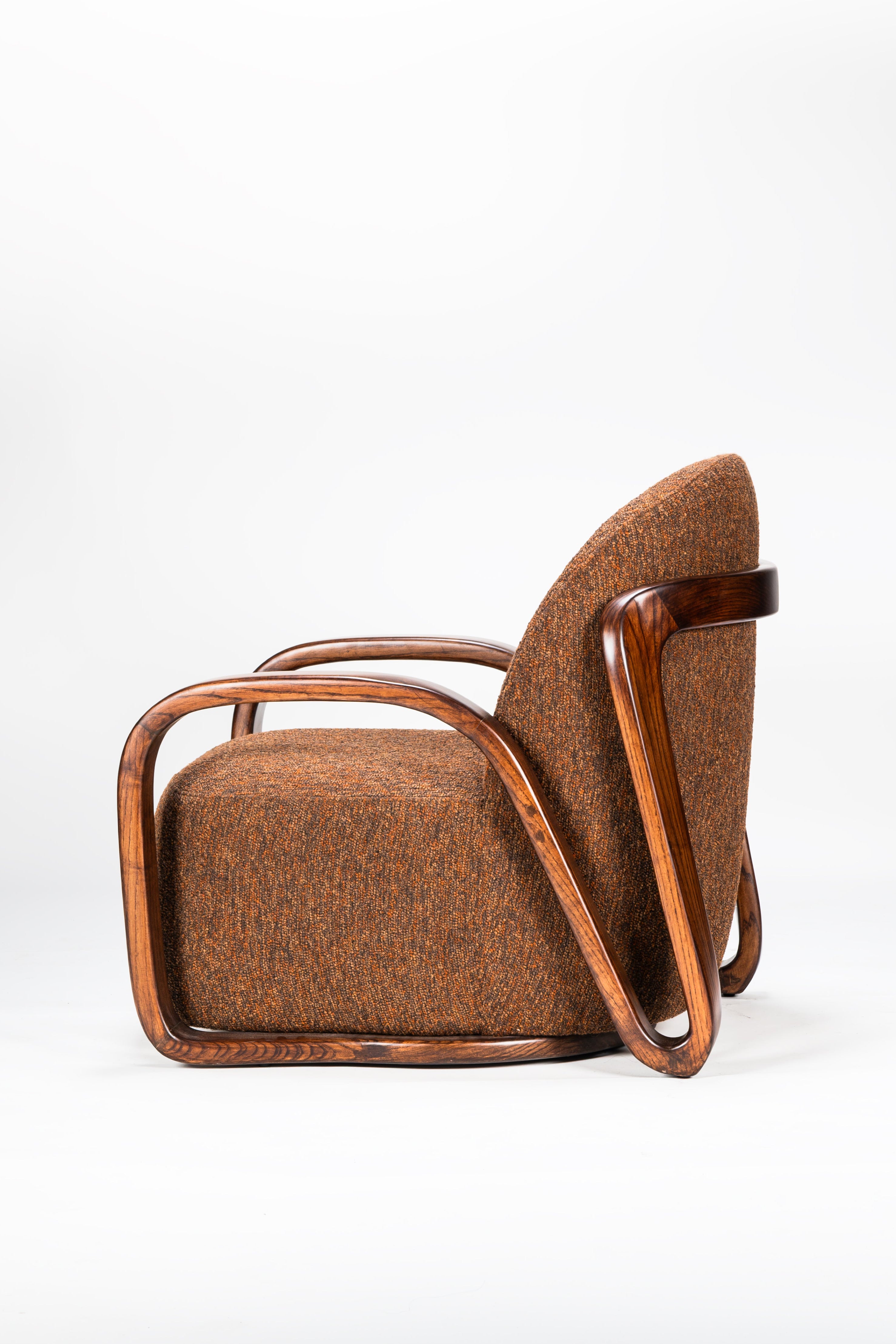 Brown armchair with wooden frame on a white background