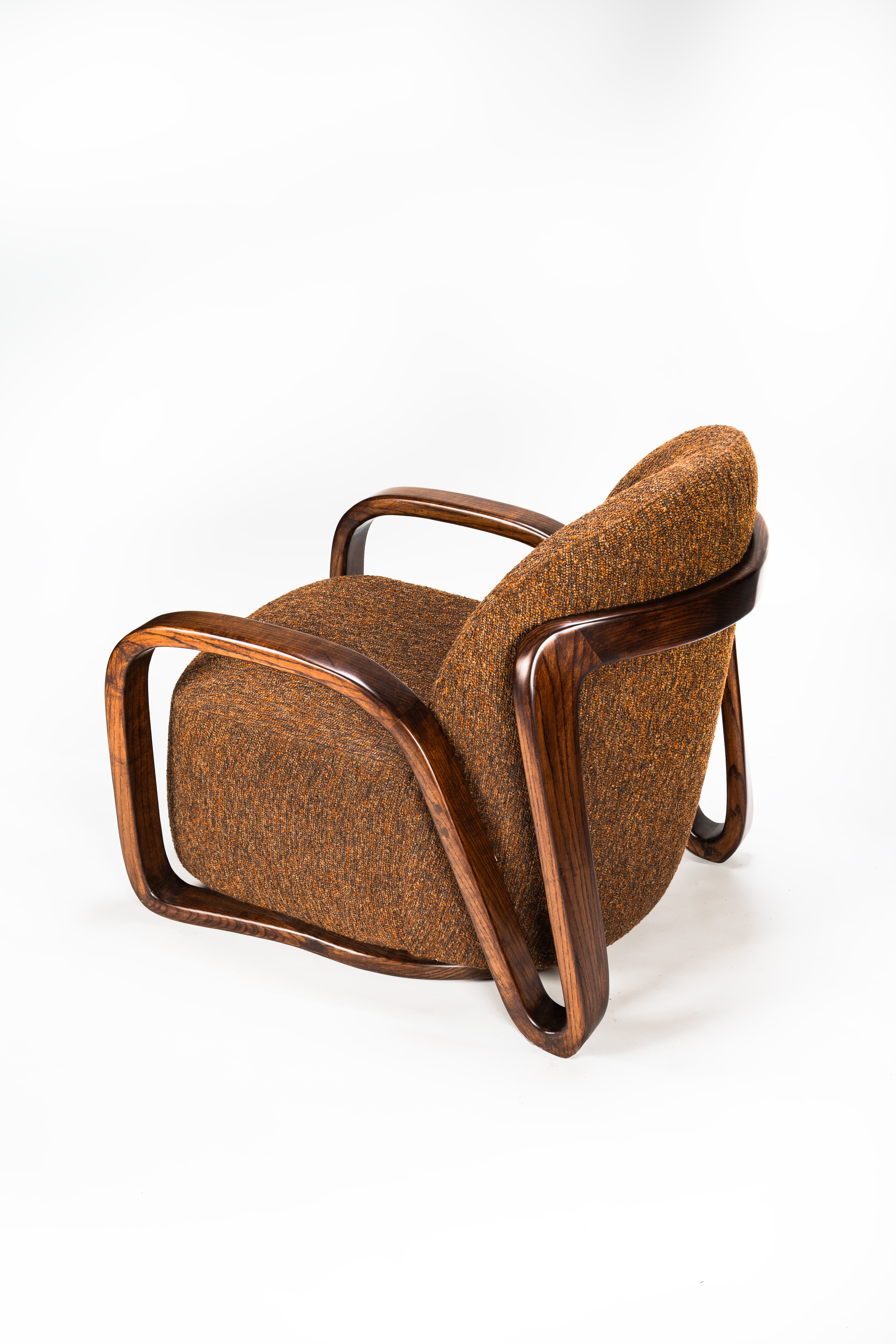 Brown upholstered chair with wooden frame on a white background