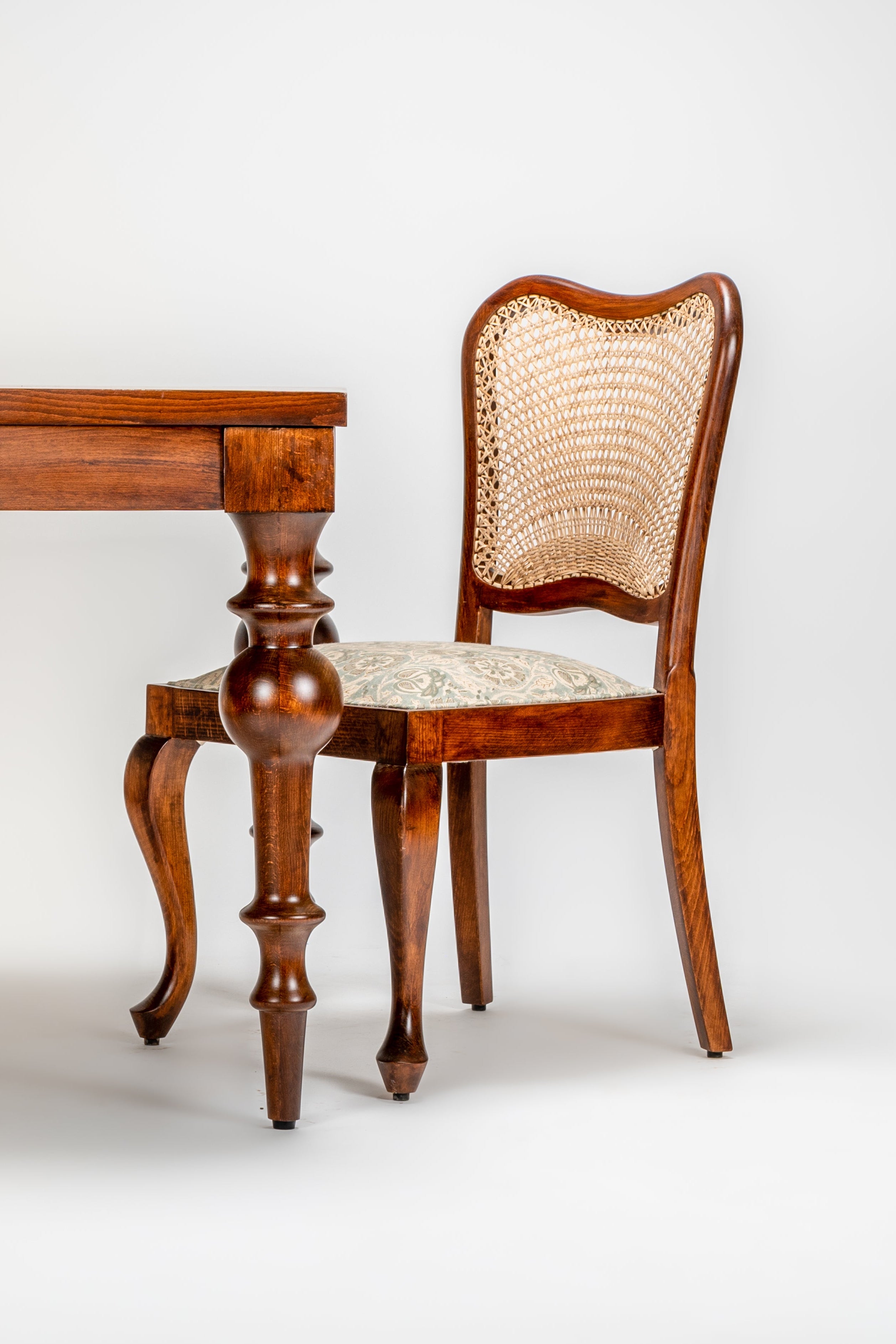 Wooden table and chair against a white background