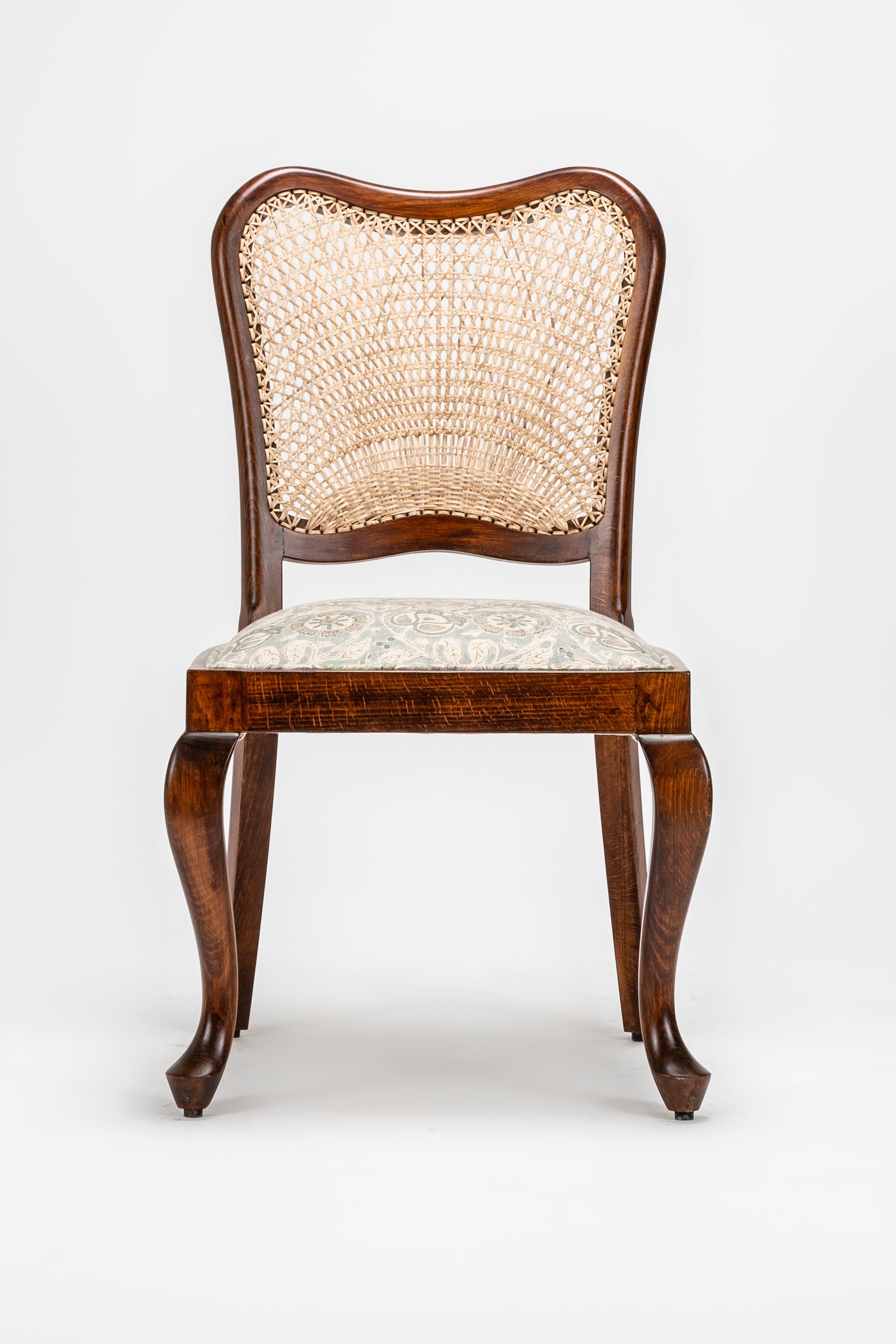 Wooden chair with a woven backrest on a white background