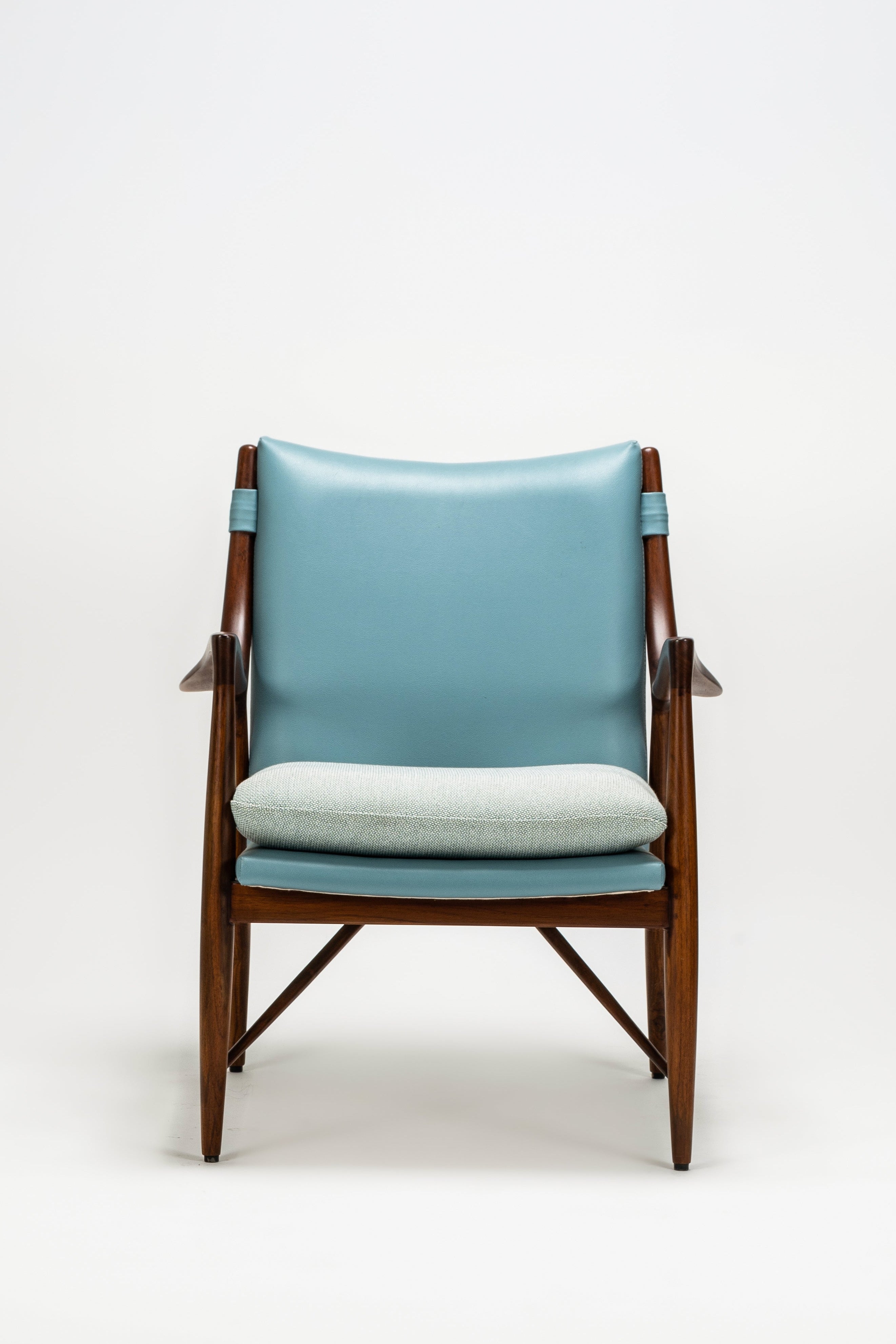 Chair with blue cushion on a white background