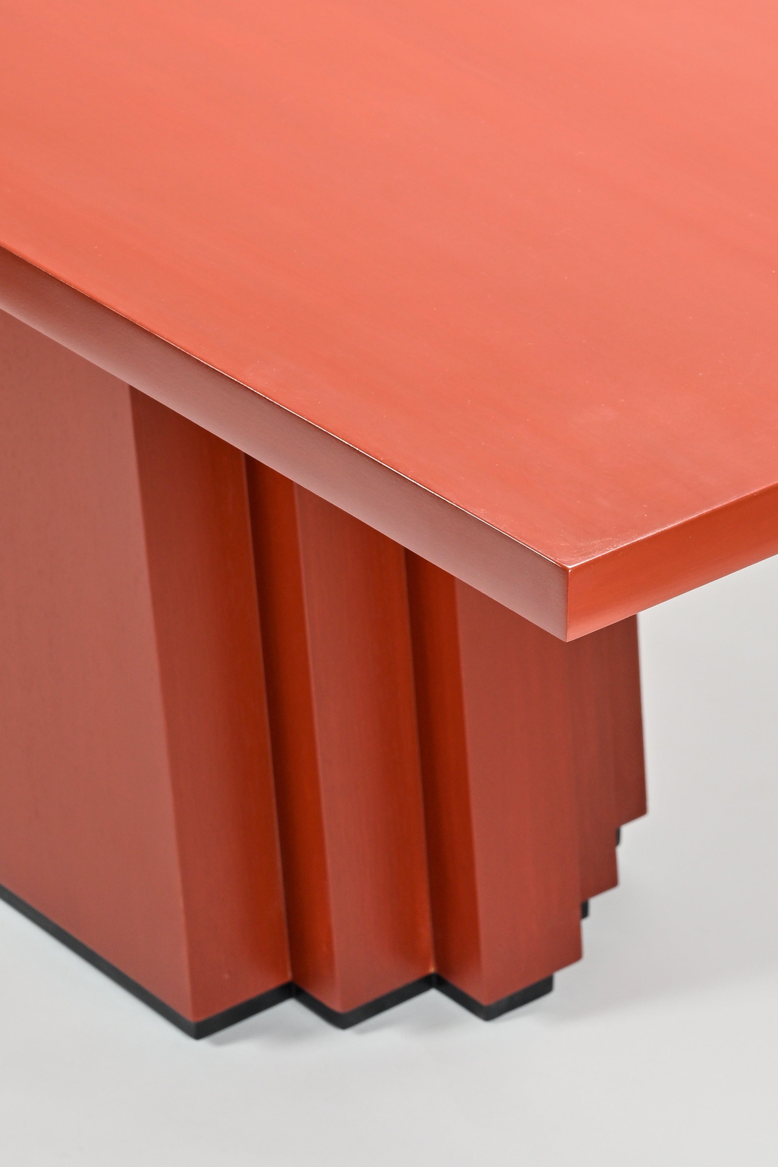 Red table with a geometric design on a white background