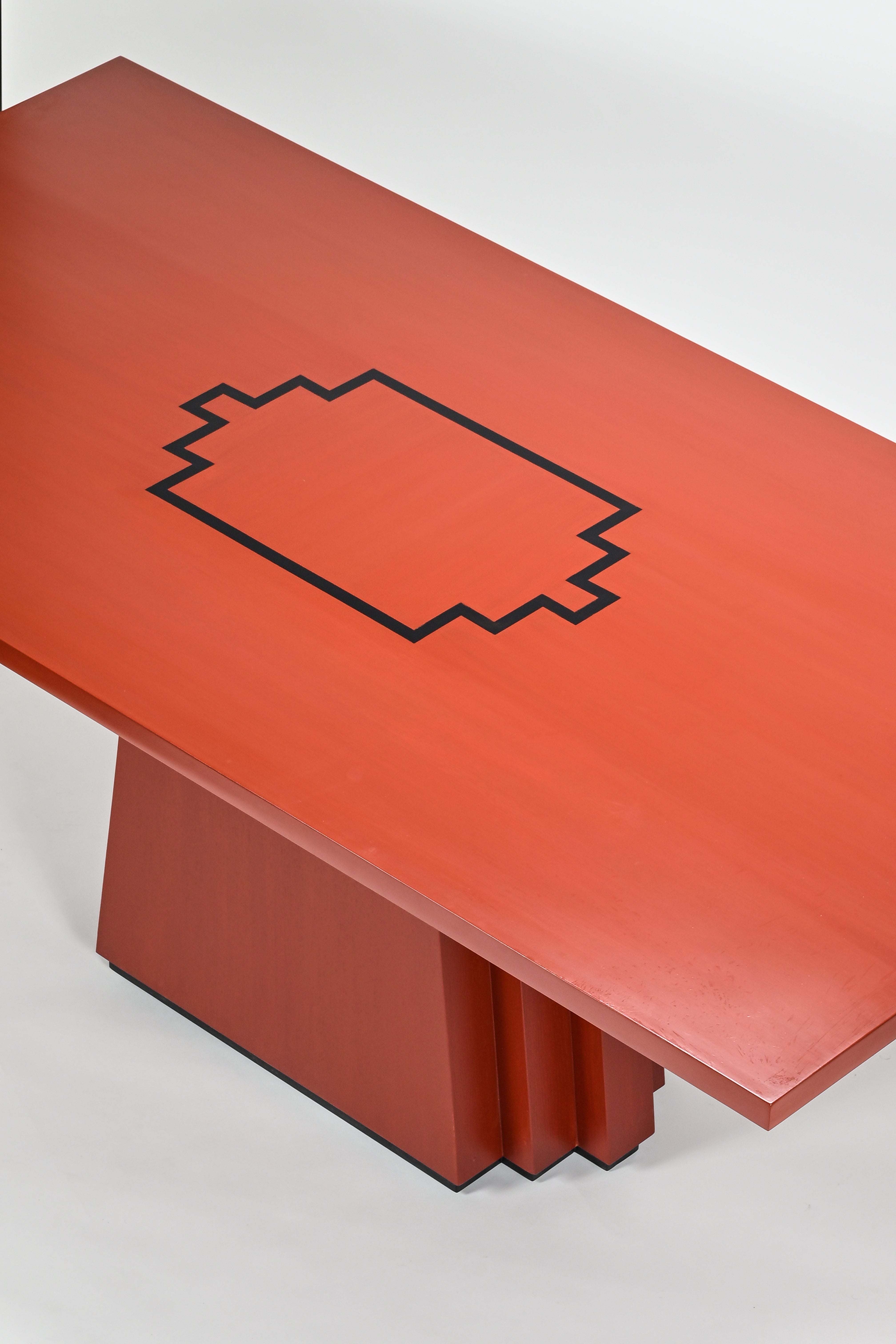 Red bench with a black geometric design on a white background