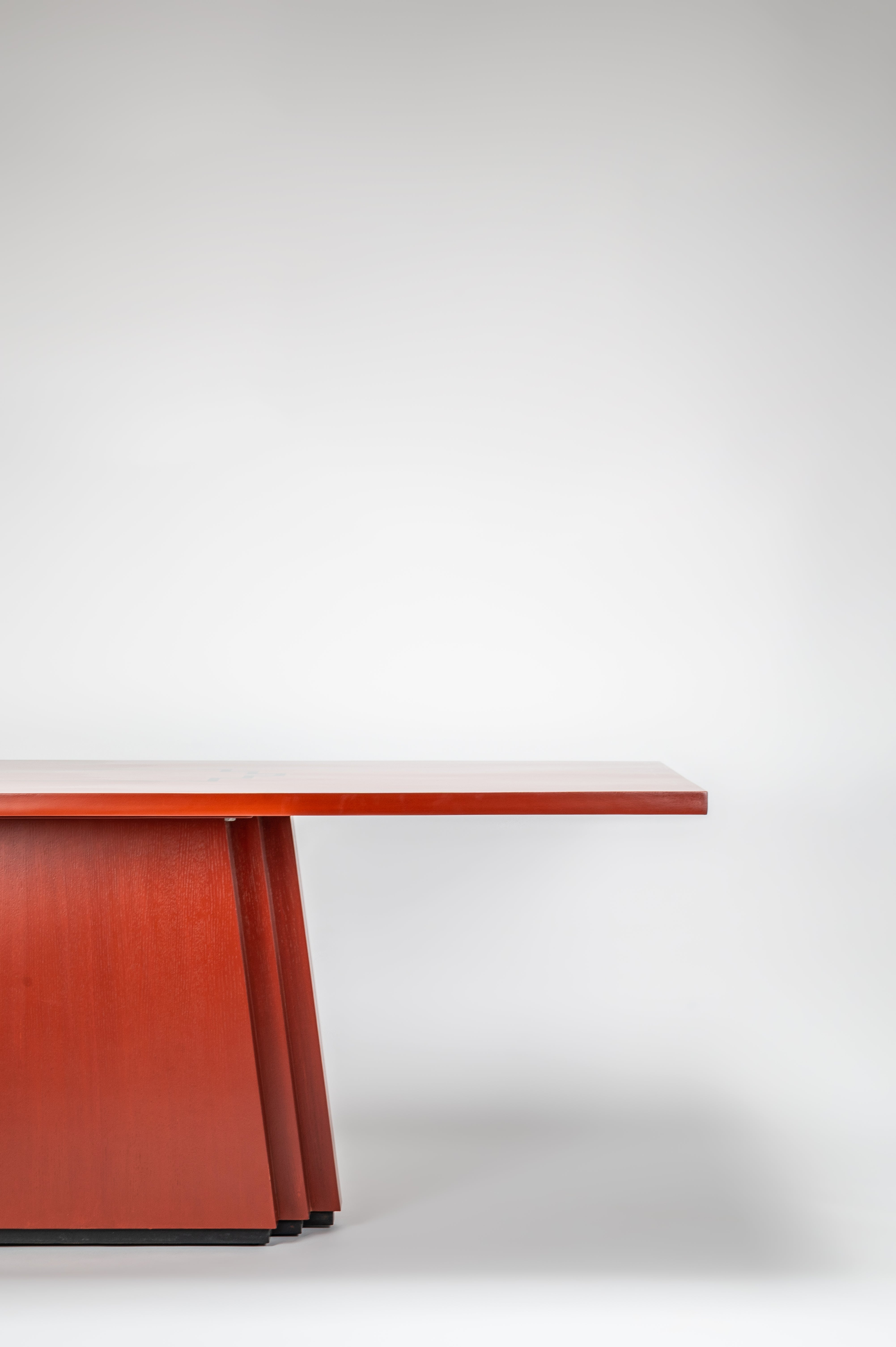 Wooden desk with a red-brown finish on a white background