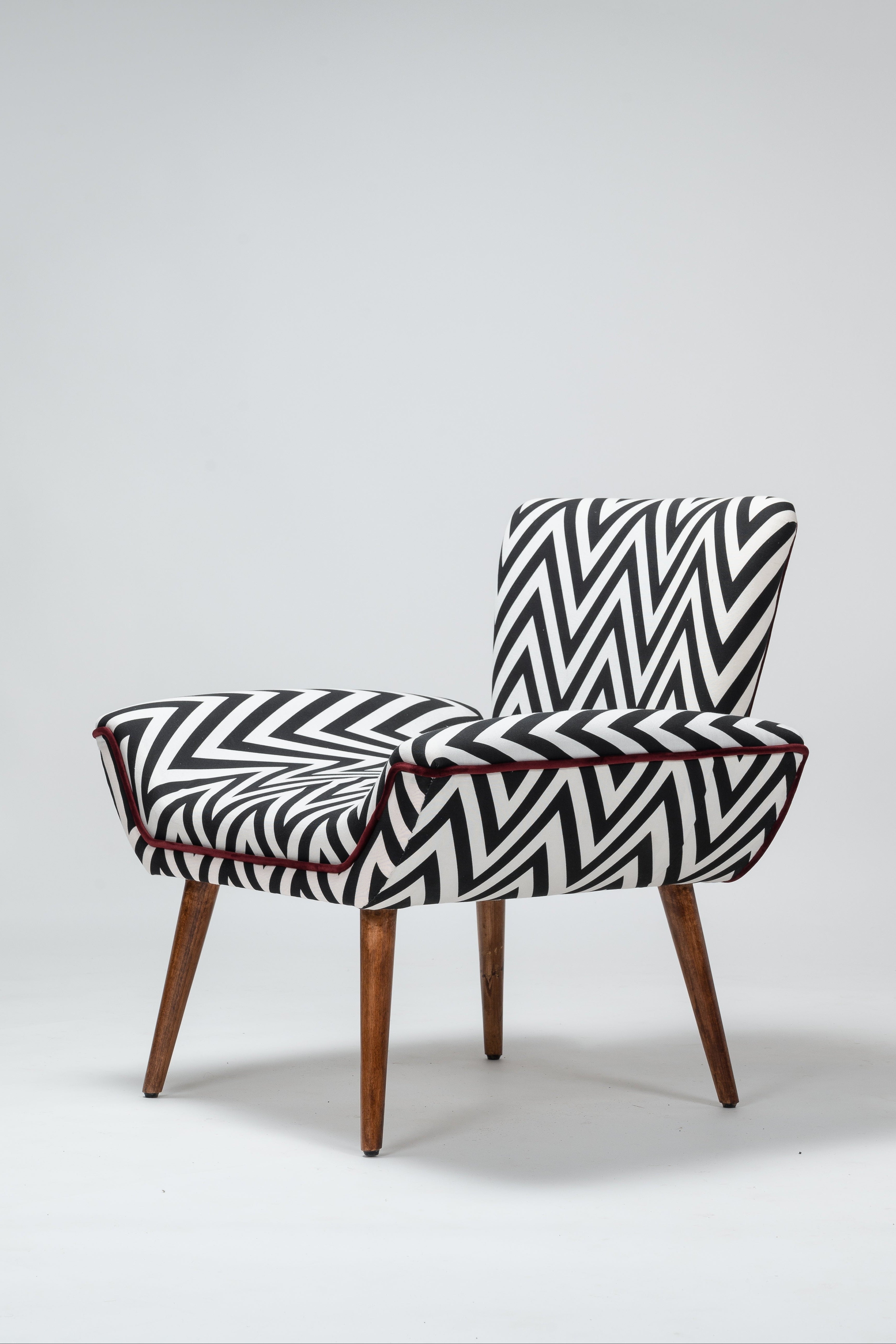 Chair with black and white zigzag pattern on a light gray background