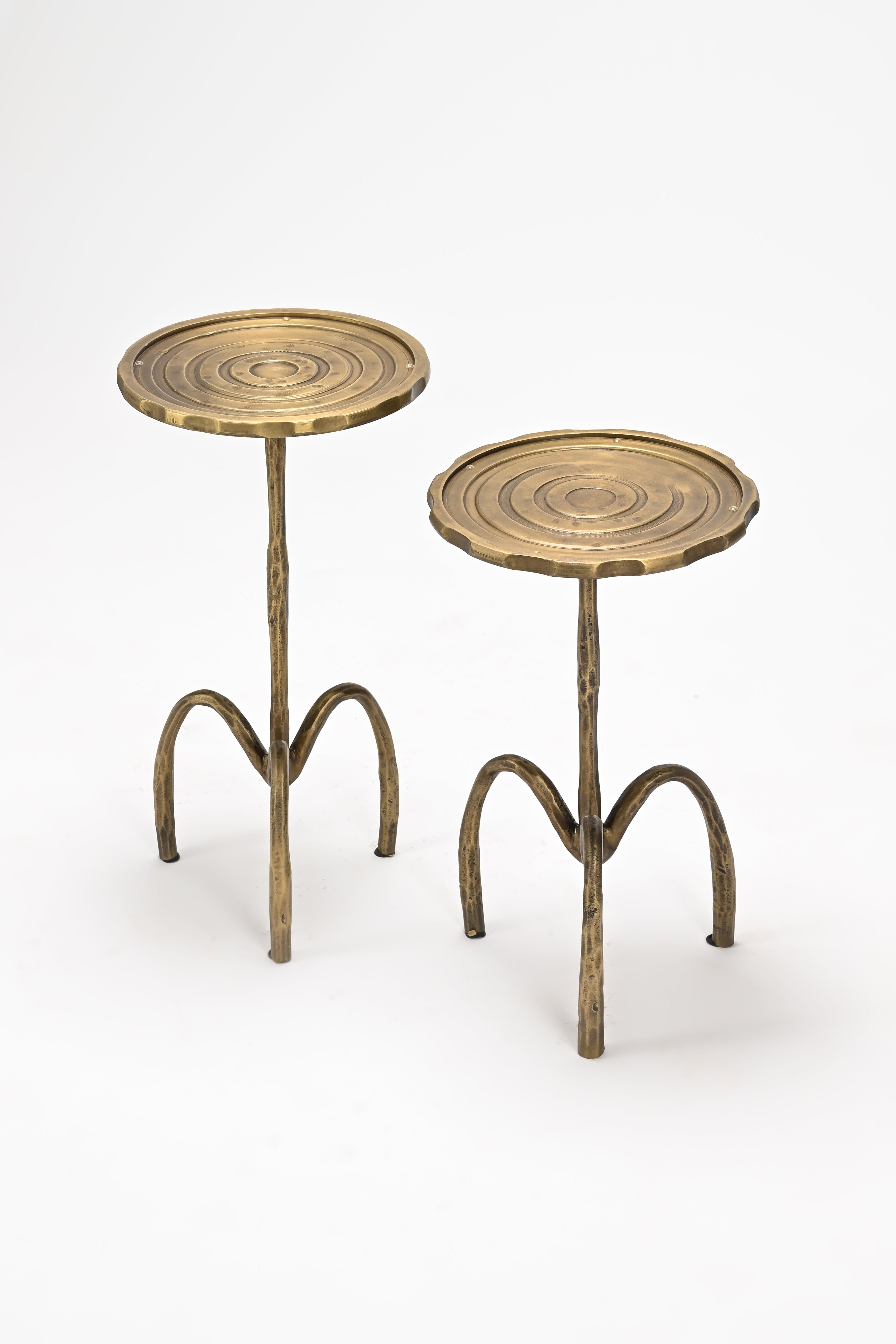 Two small round tables with spiral designs on a white background