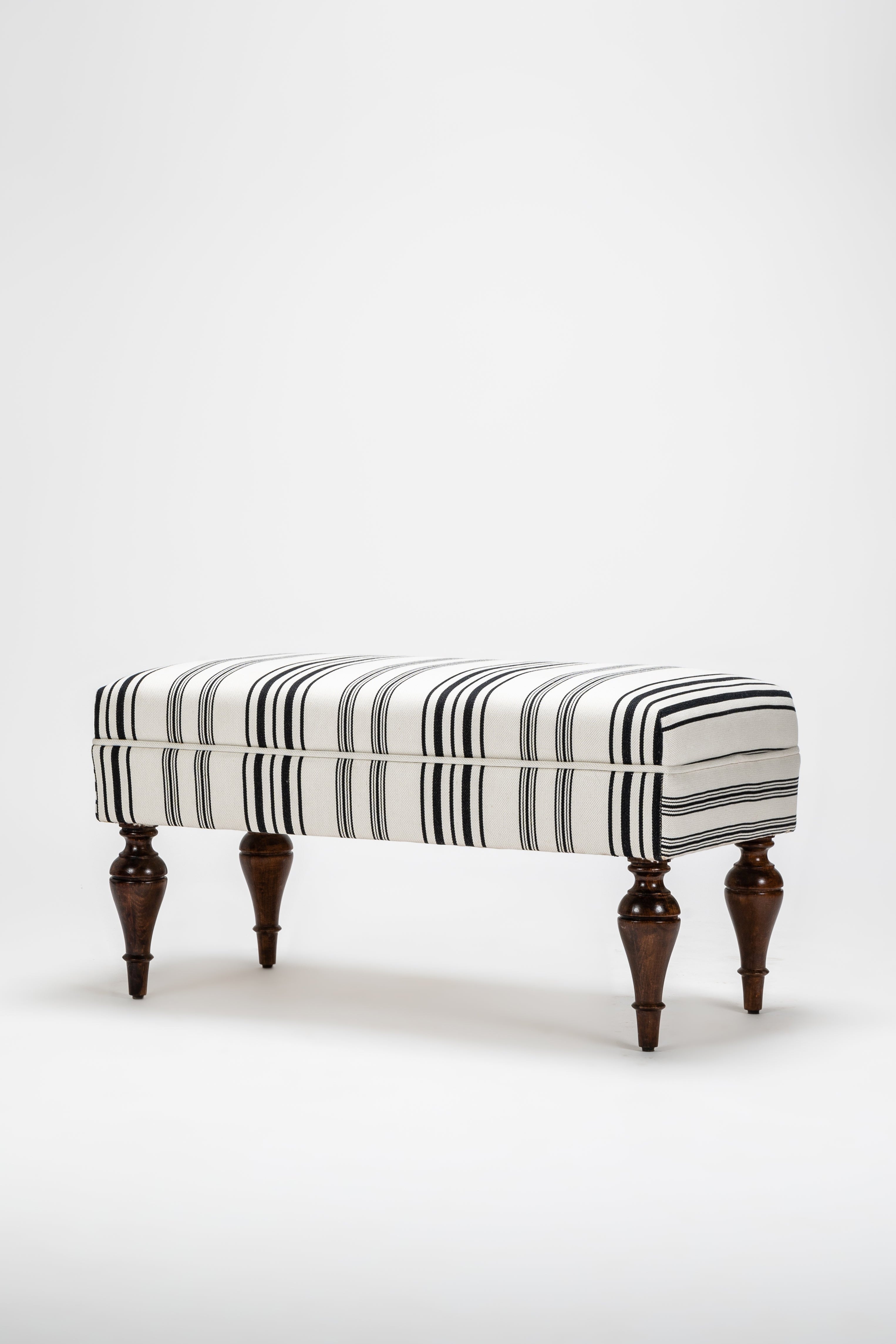 Striped ottoman with wooden legs on a white background