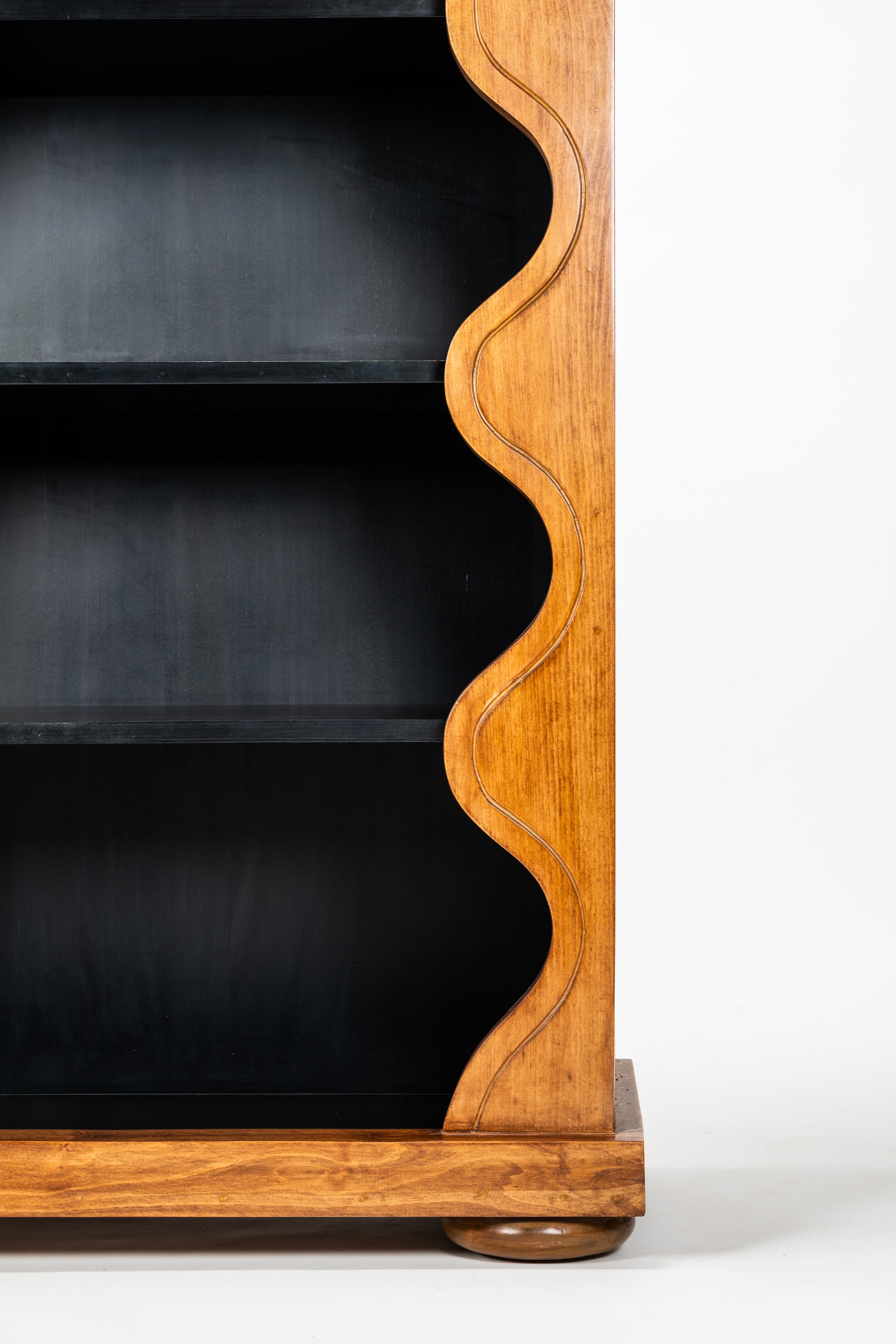 Wooden bookshelf with wavy design on a white background