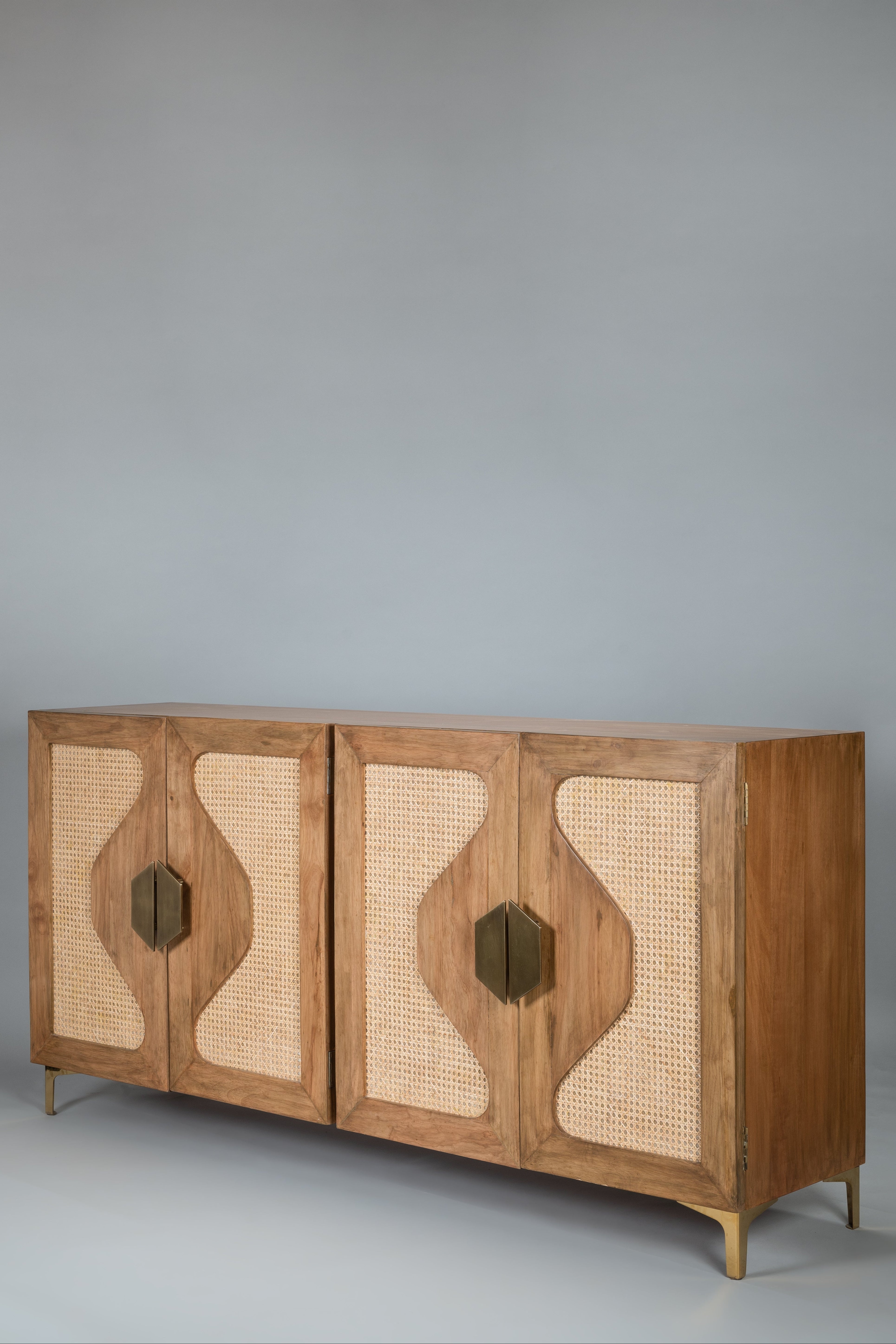 Wooden sideboard with wicker panels on a gray background