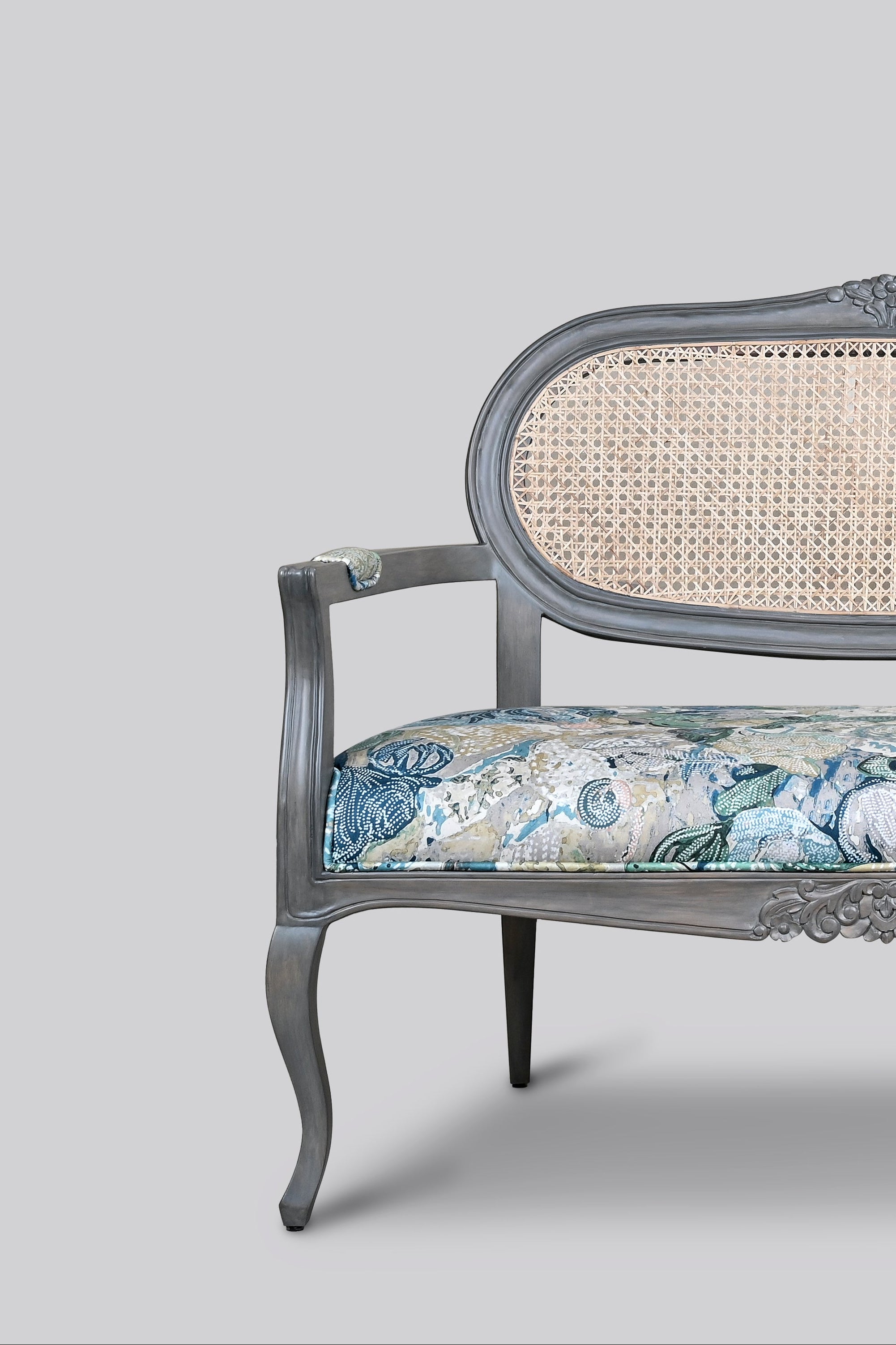 Decorative settee with floral pattern on a gray background