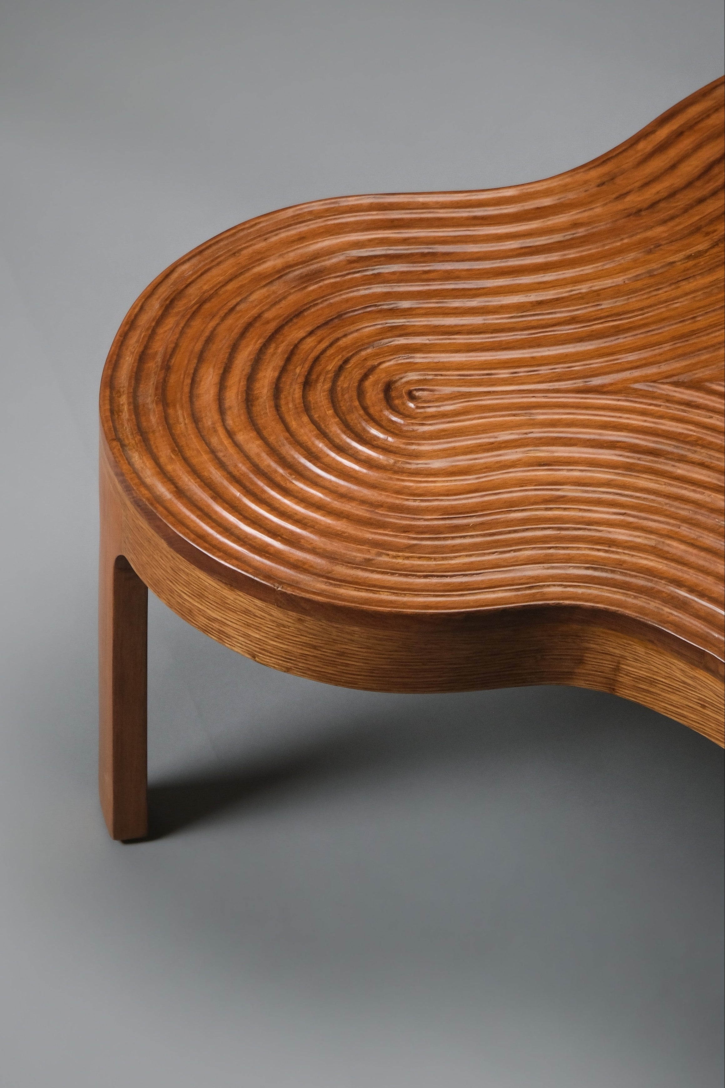 Wooden chair with wavy pattern on a gray background