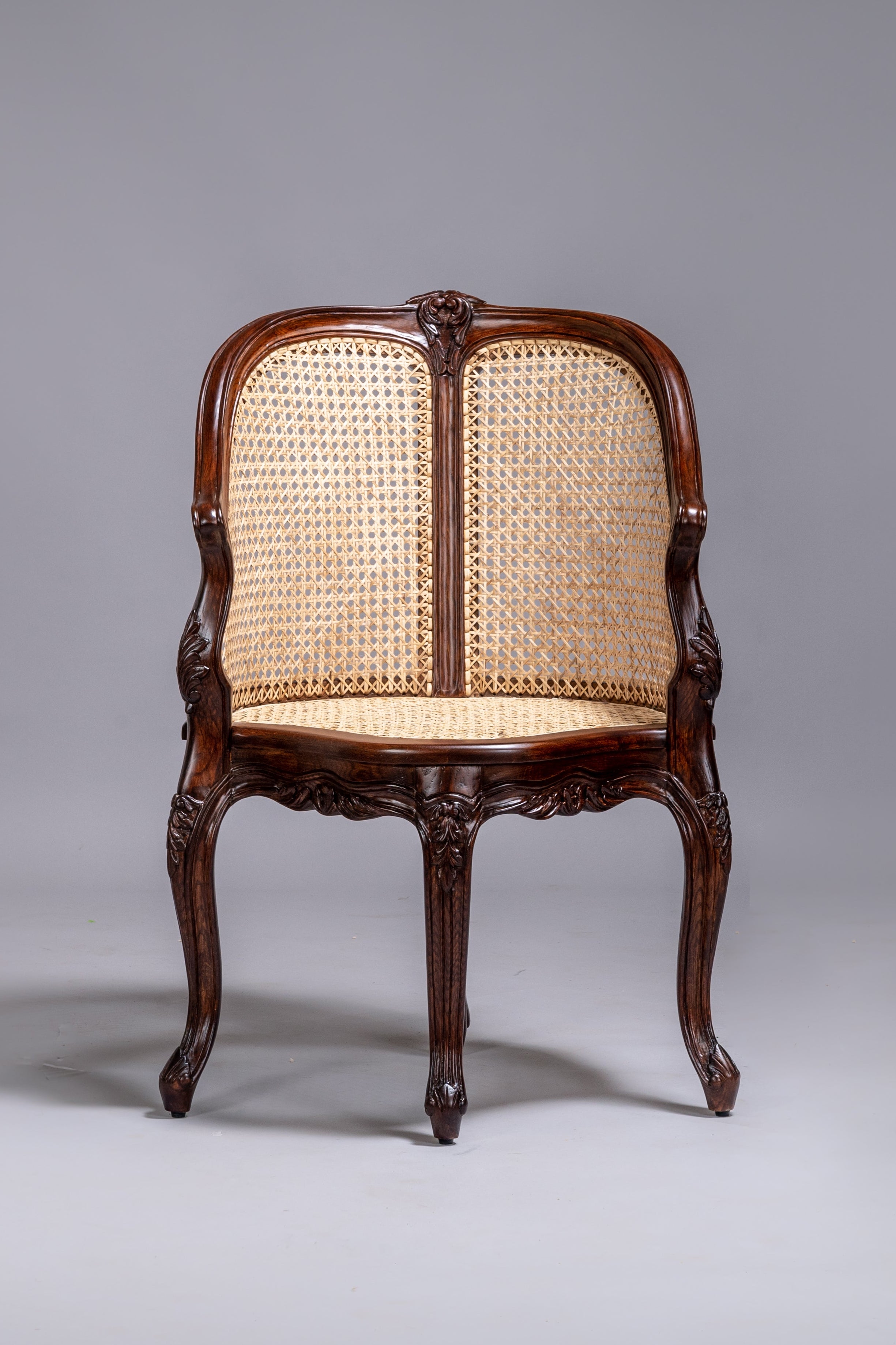 Wooden chair with wicker backrest on a gray background