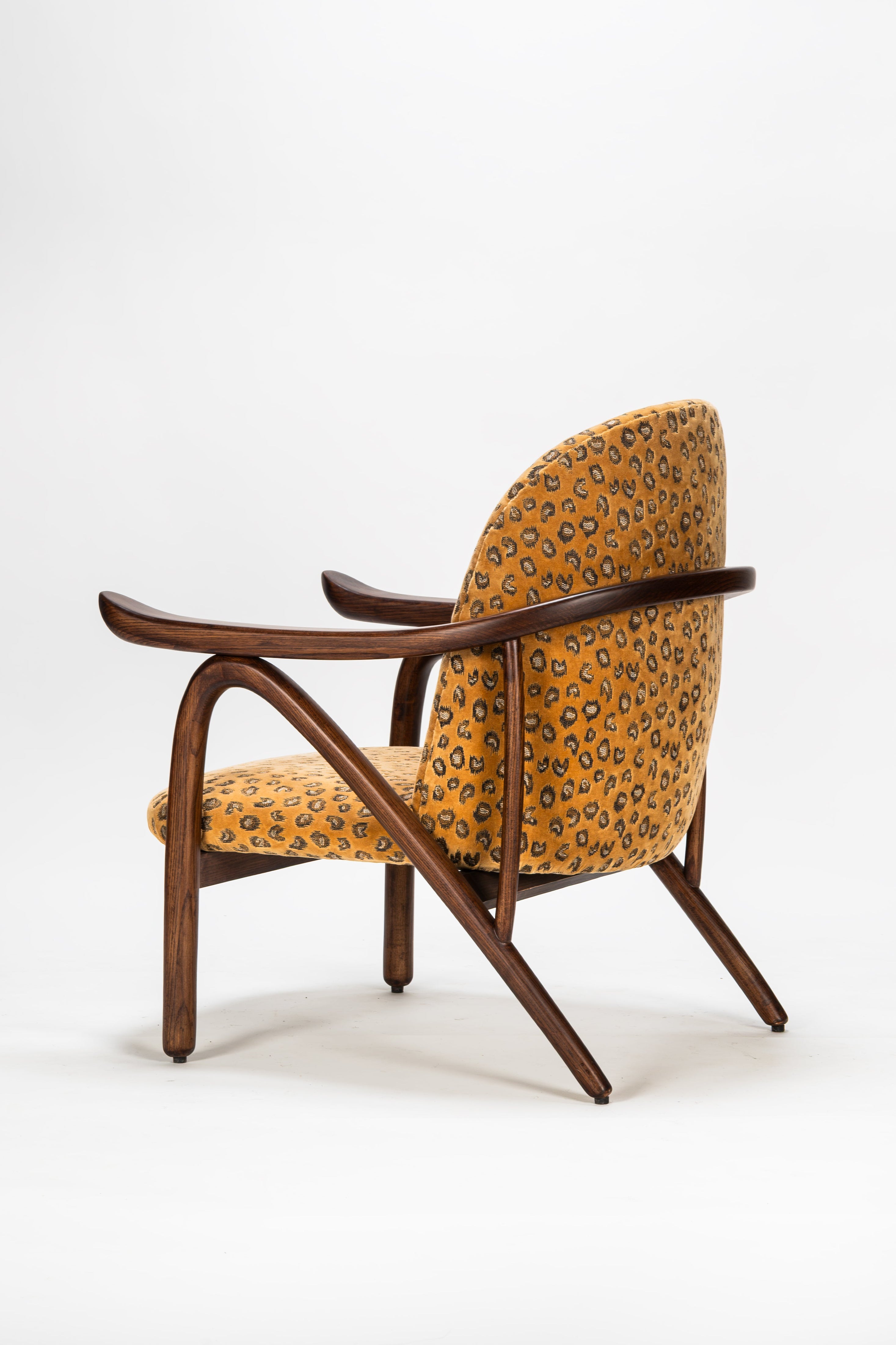 Chair with wooden frame and patterned fabric on a white background