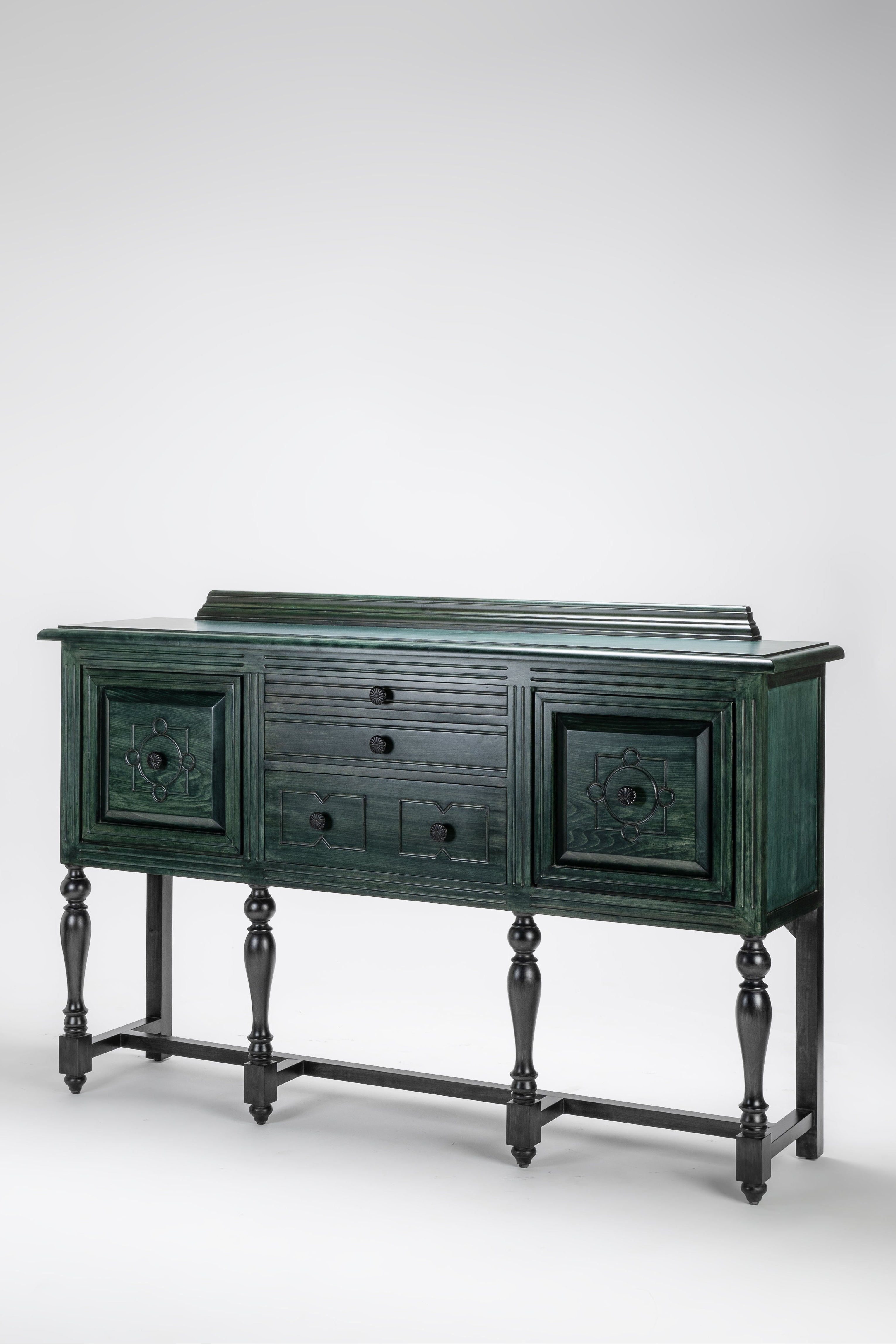 Dark green wooden sideboard with decorative elements on a white background