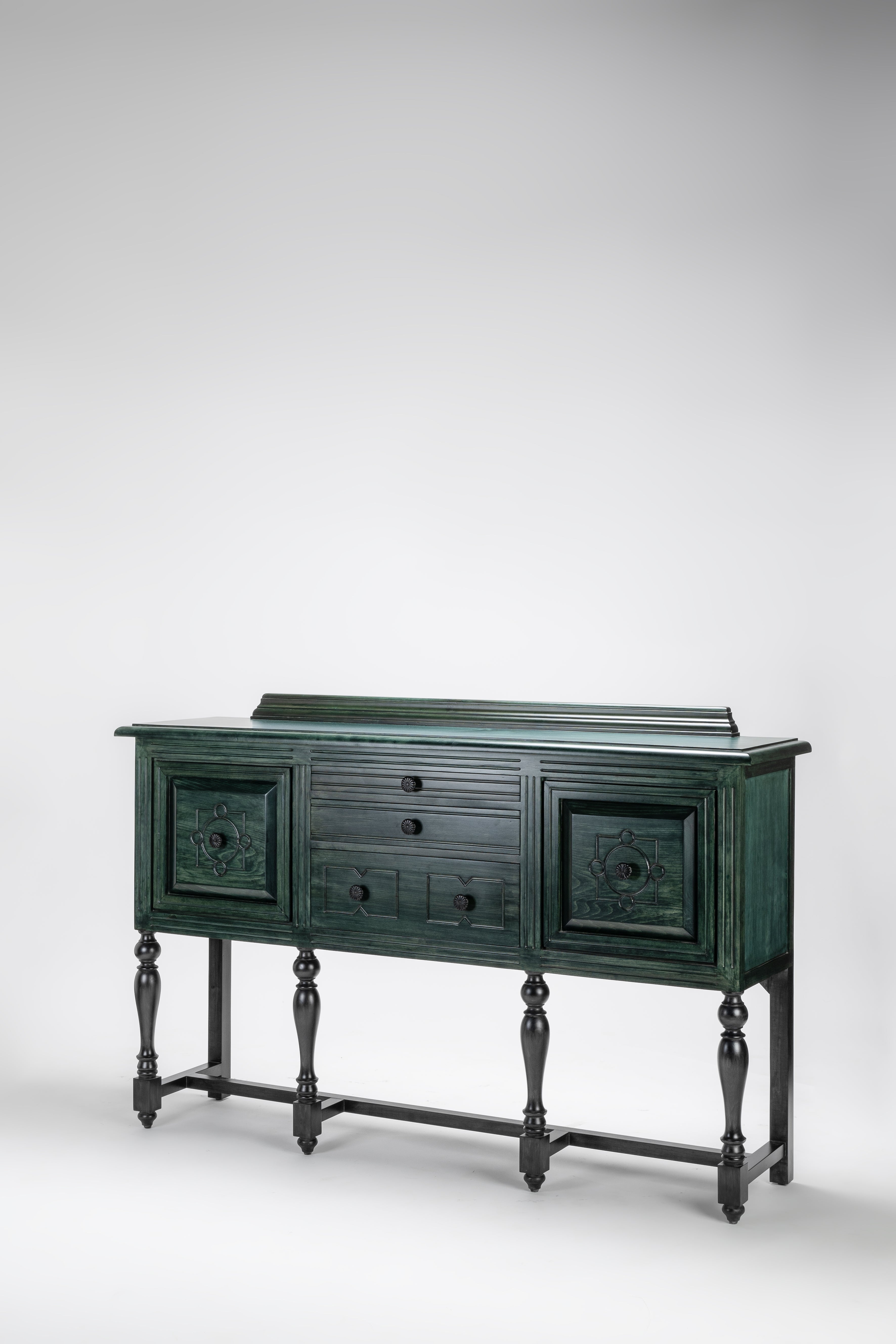 Dark green wooden sideboard with decorative elements on a white background