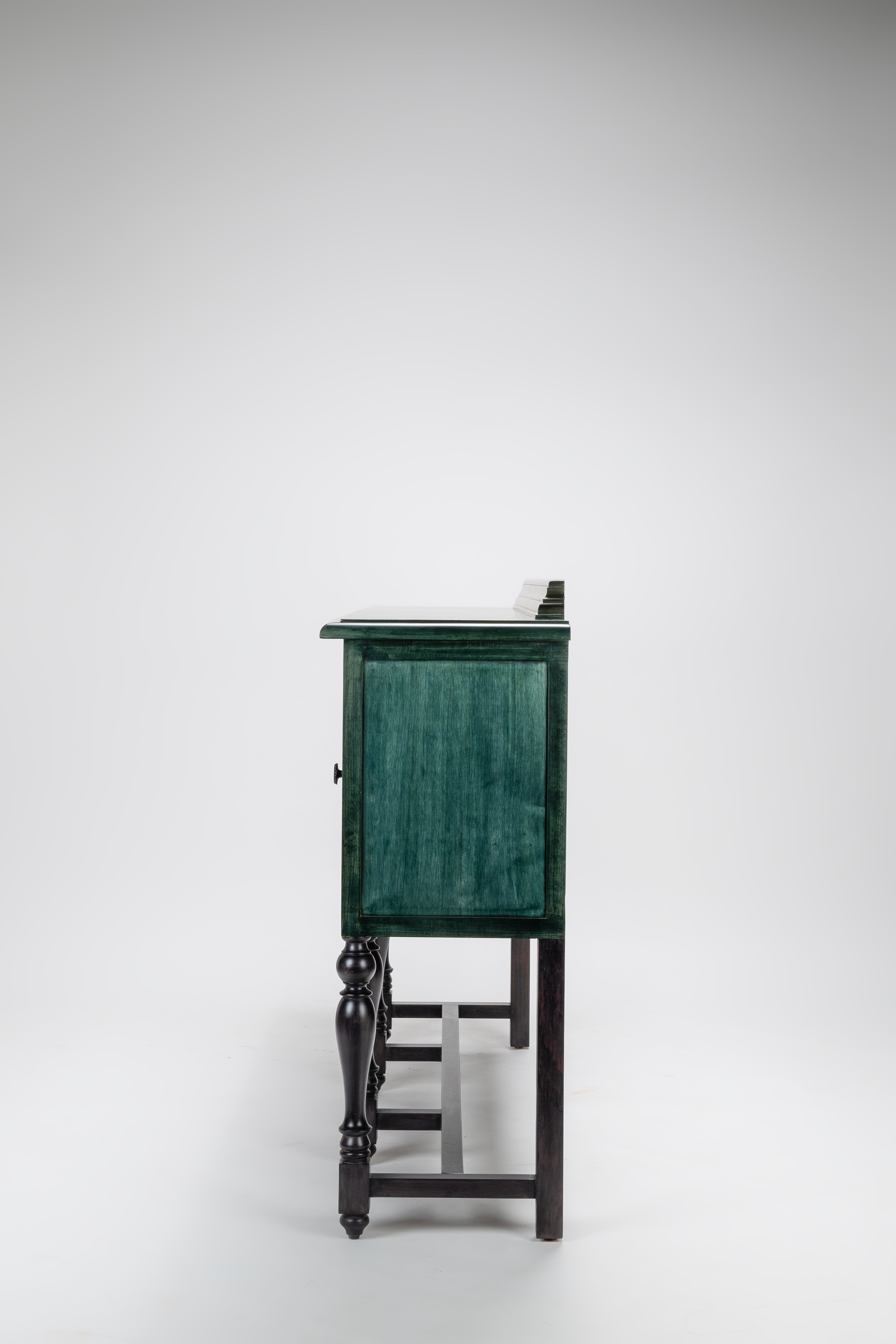 Green cabinet with black legs on a white background