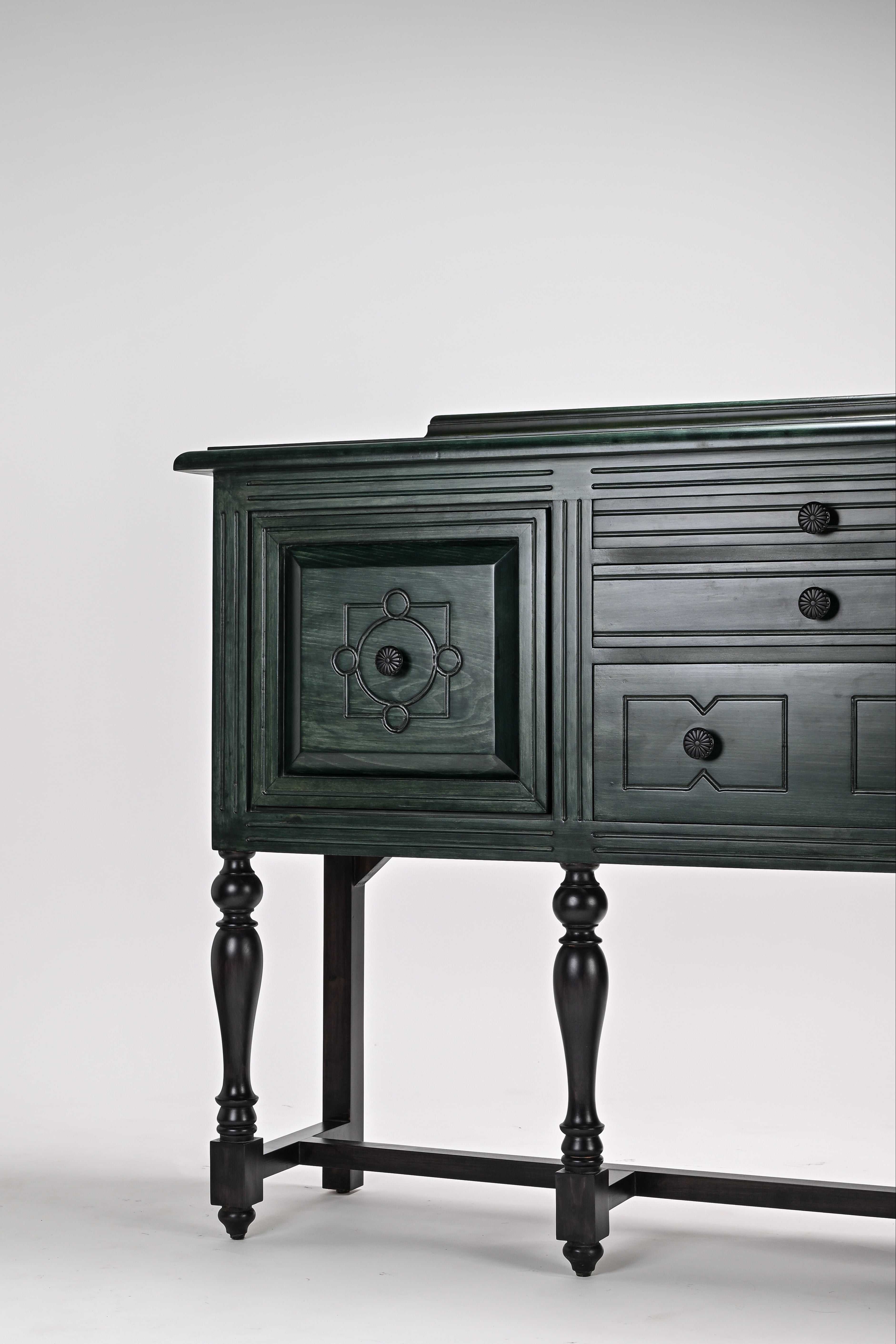 Dark green wooden sideboard with decorative elements on a white background