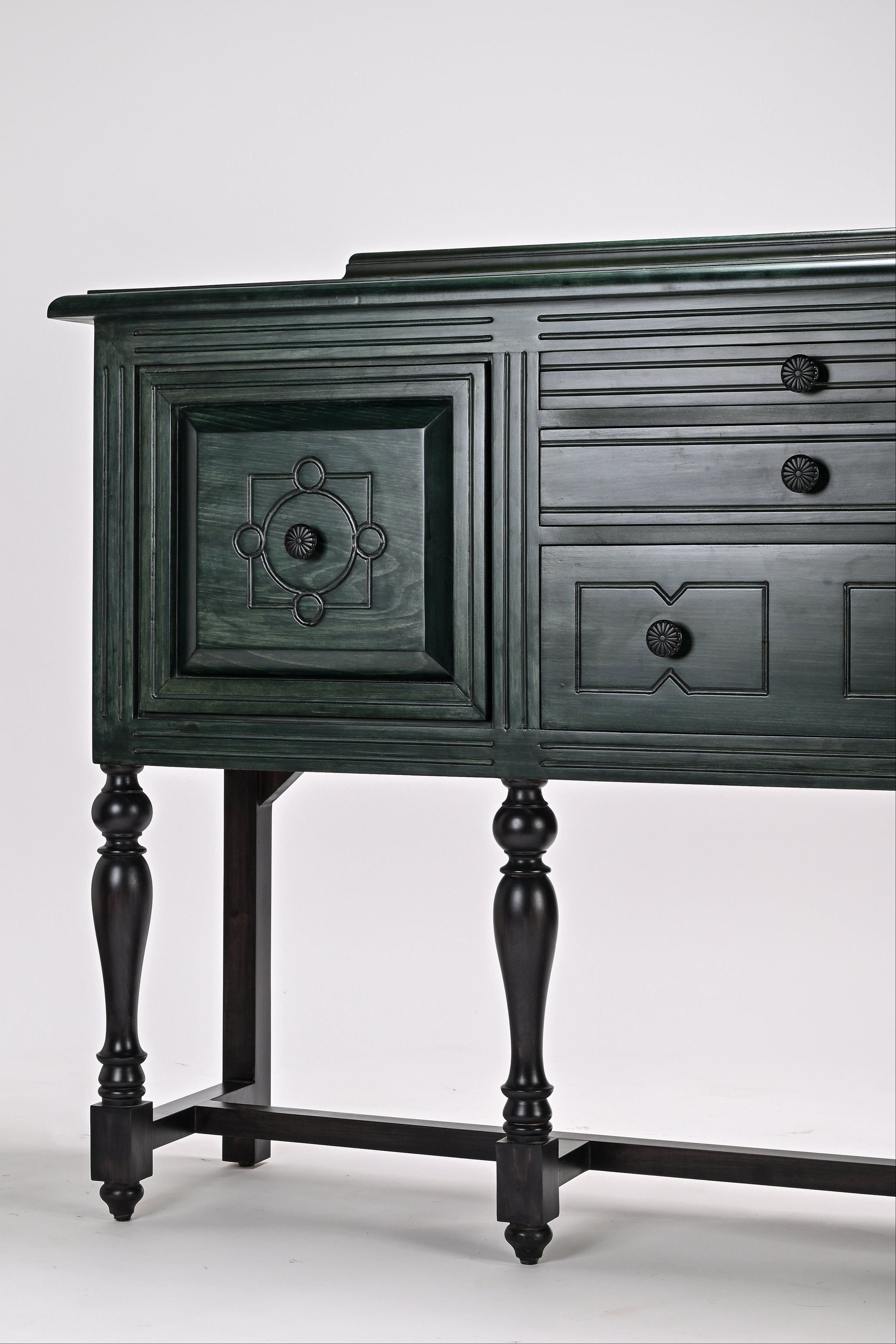 Dark green wooden sideboard with decorative elements on a white background