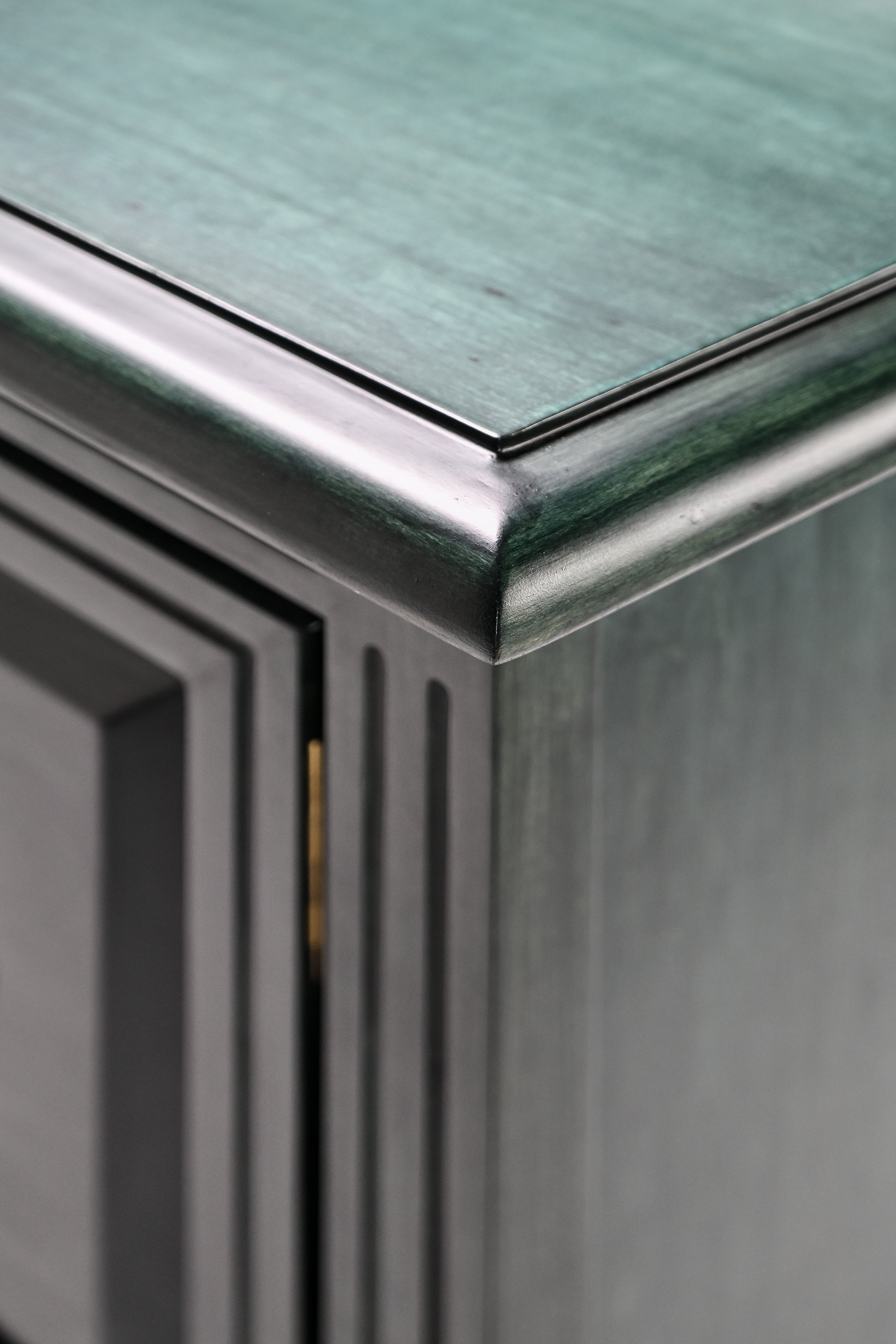 Close-up of a metallic surface with a reflective top