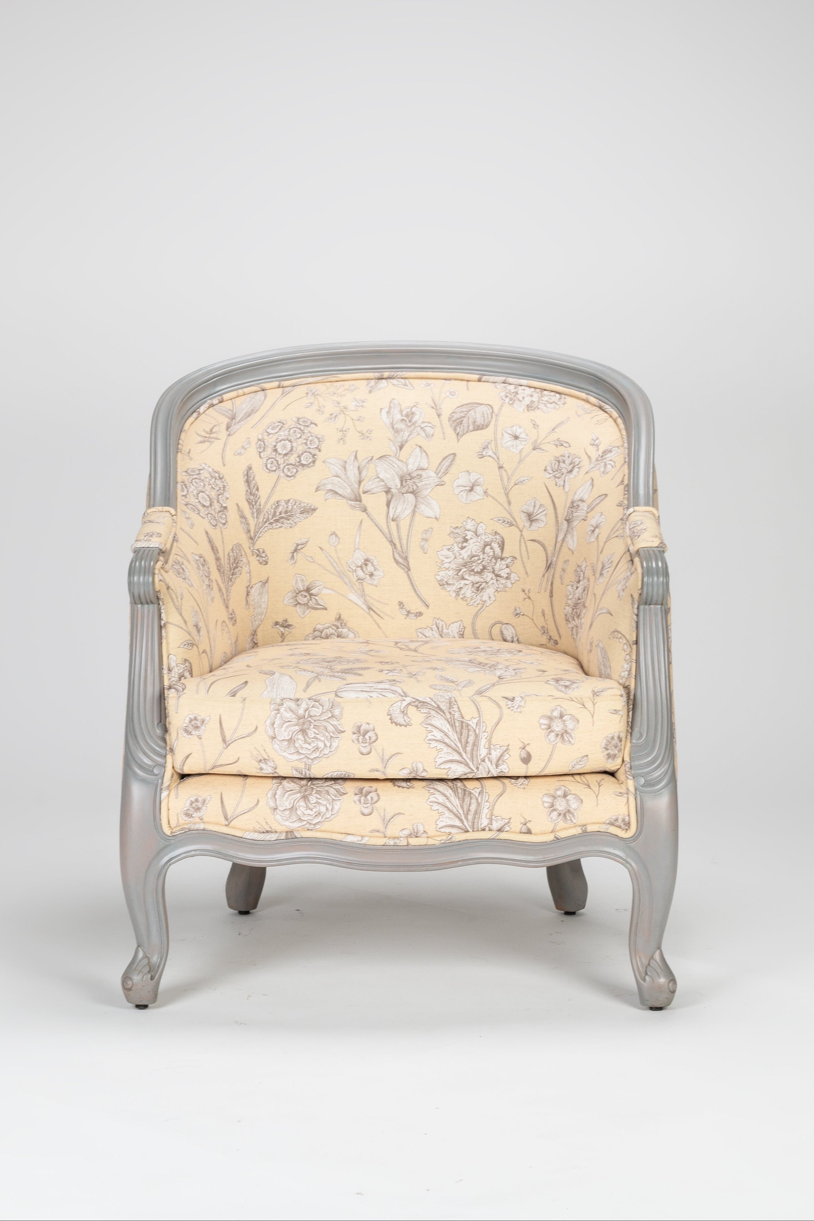 Chair with floral patterned cushion on a gray background