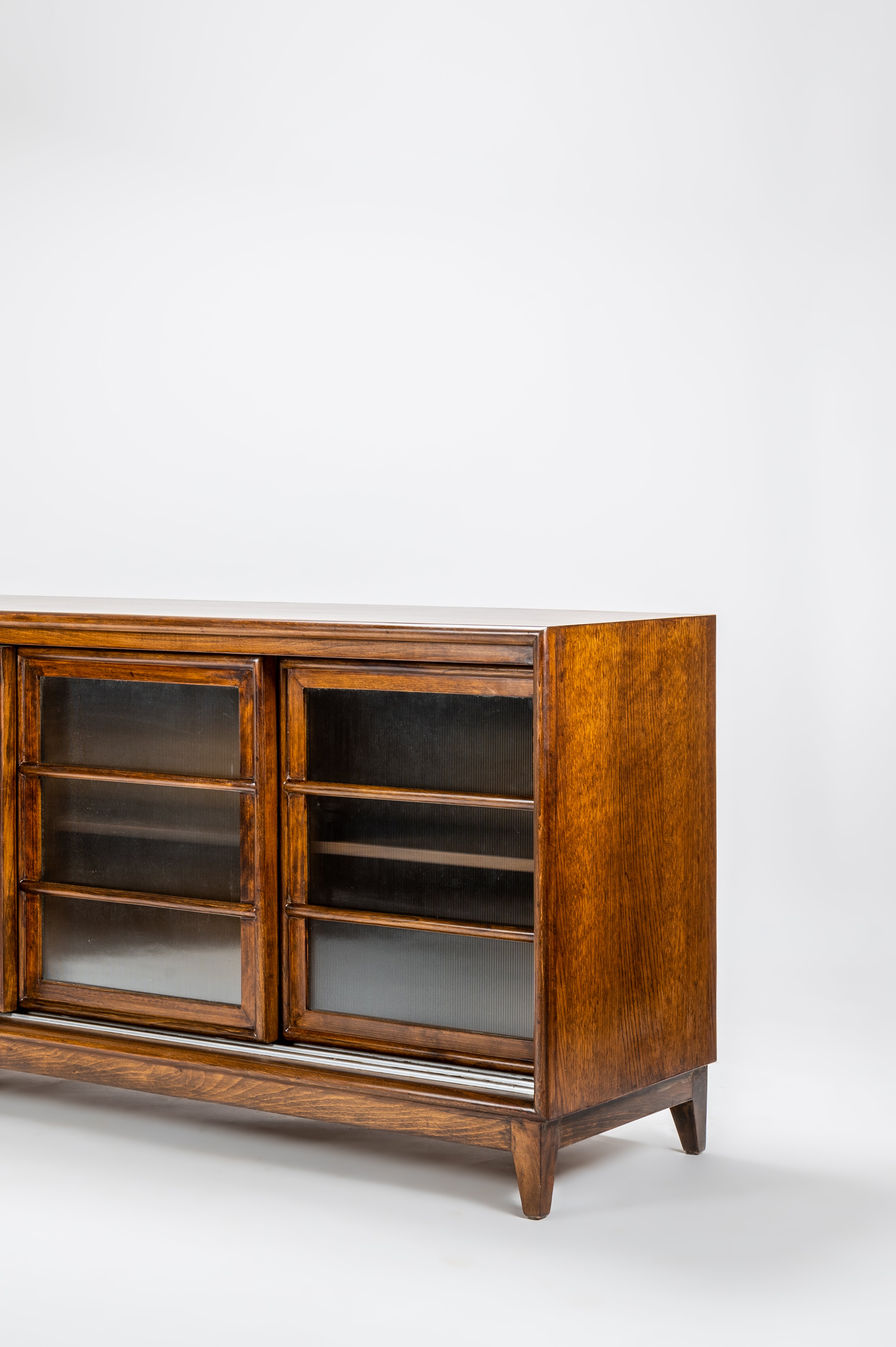 Wooden cabinet with glass doors on a white background