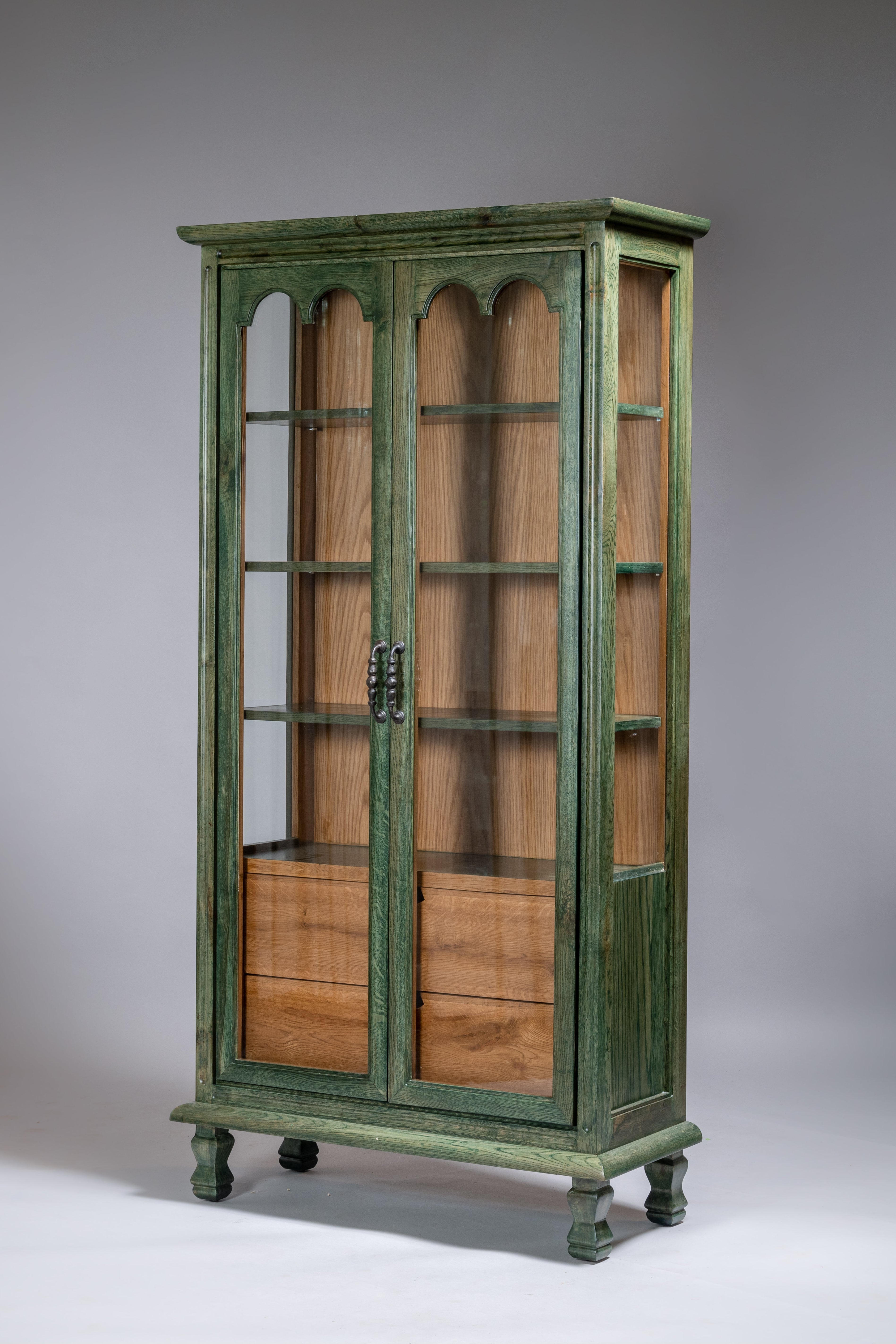 Vintage wooden cabinet with green painted frame on a gray background
