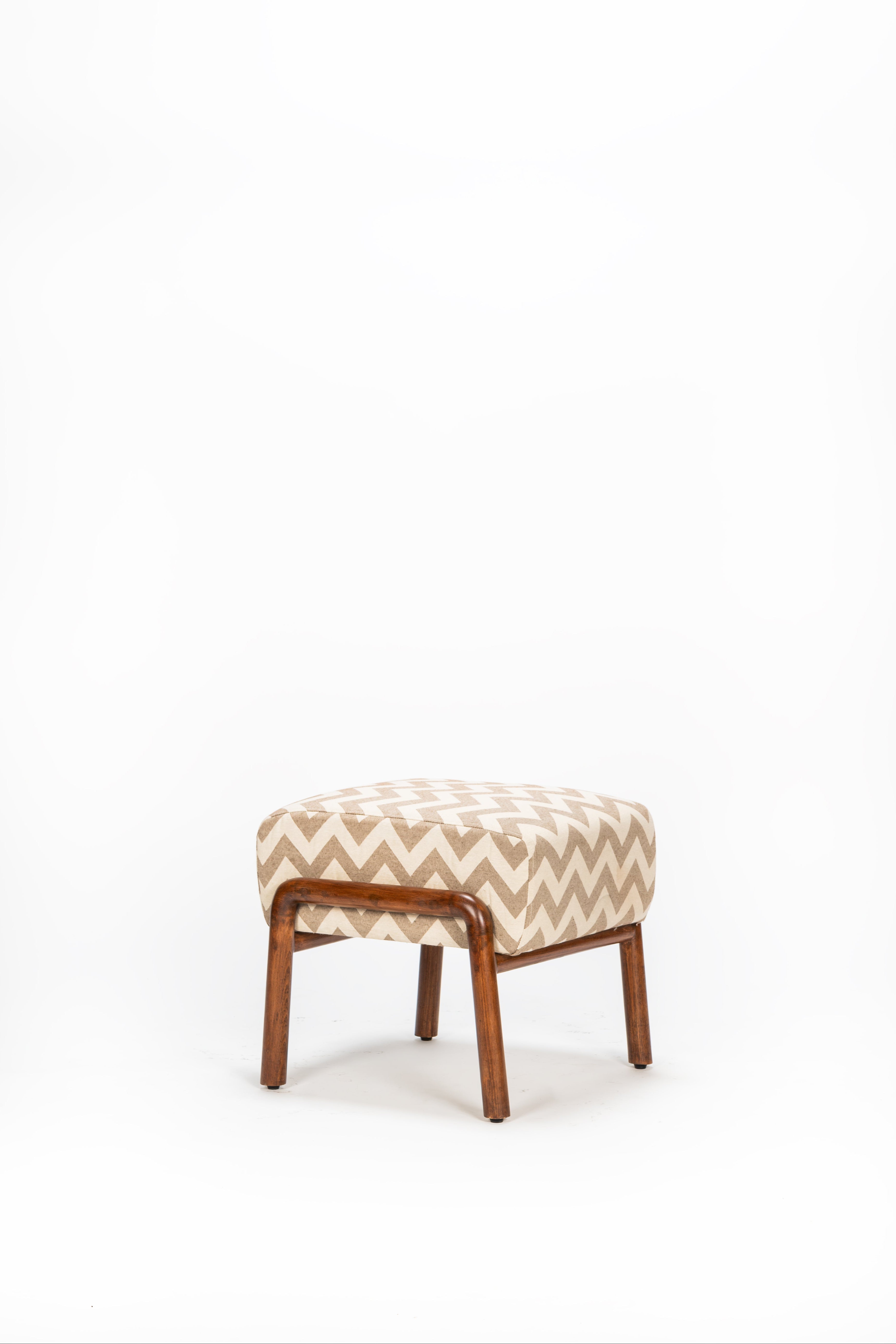 Patterned stool with wooden frame on a white background