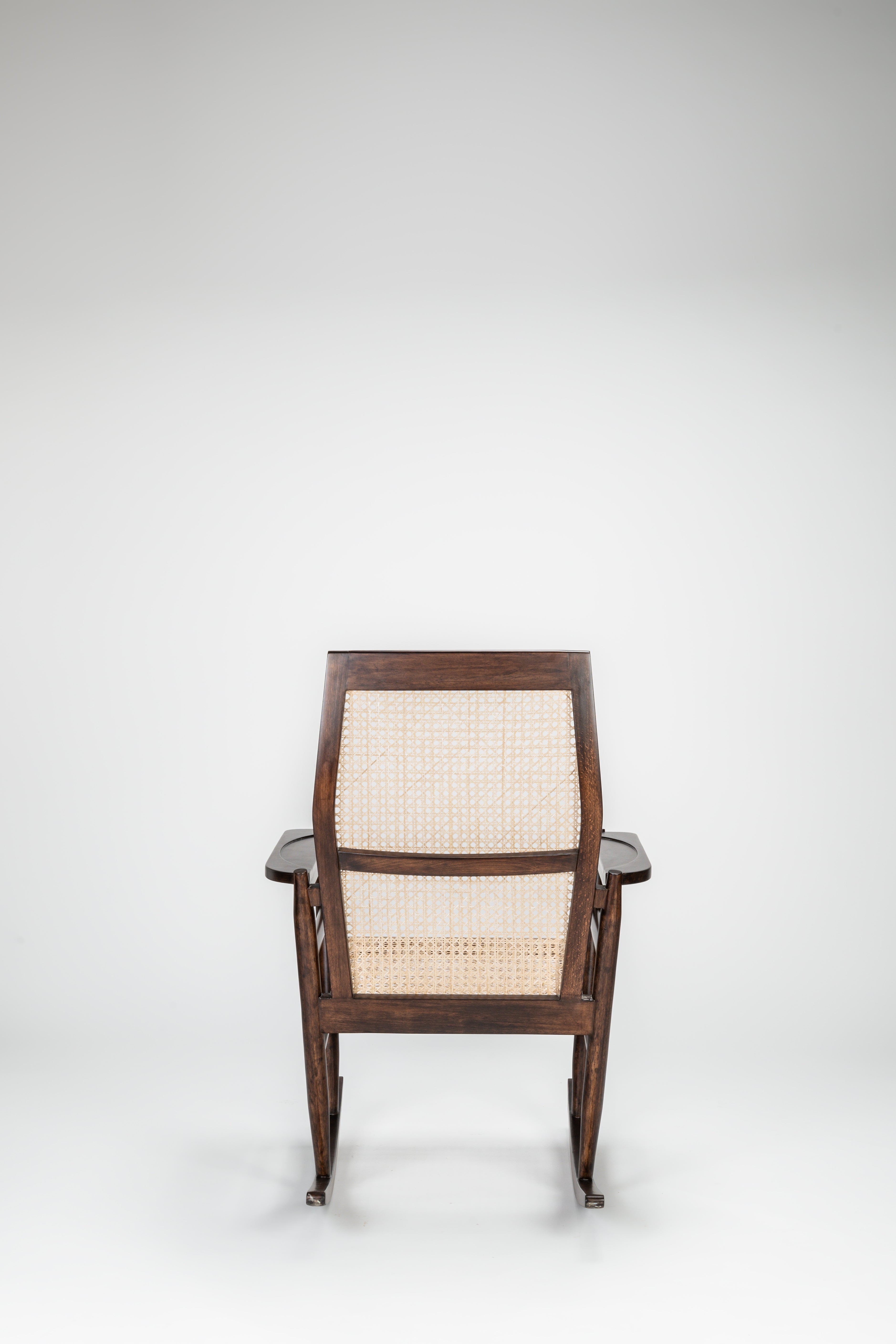 Wooden chair with a woven backrest on a white background