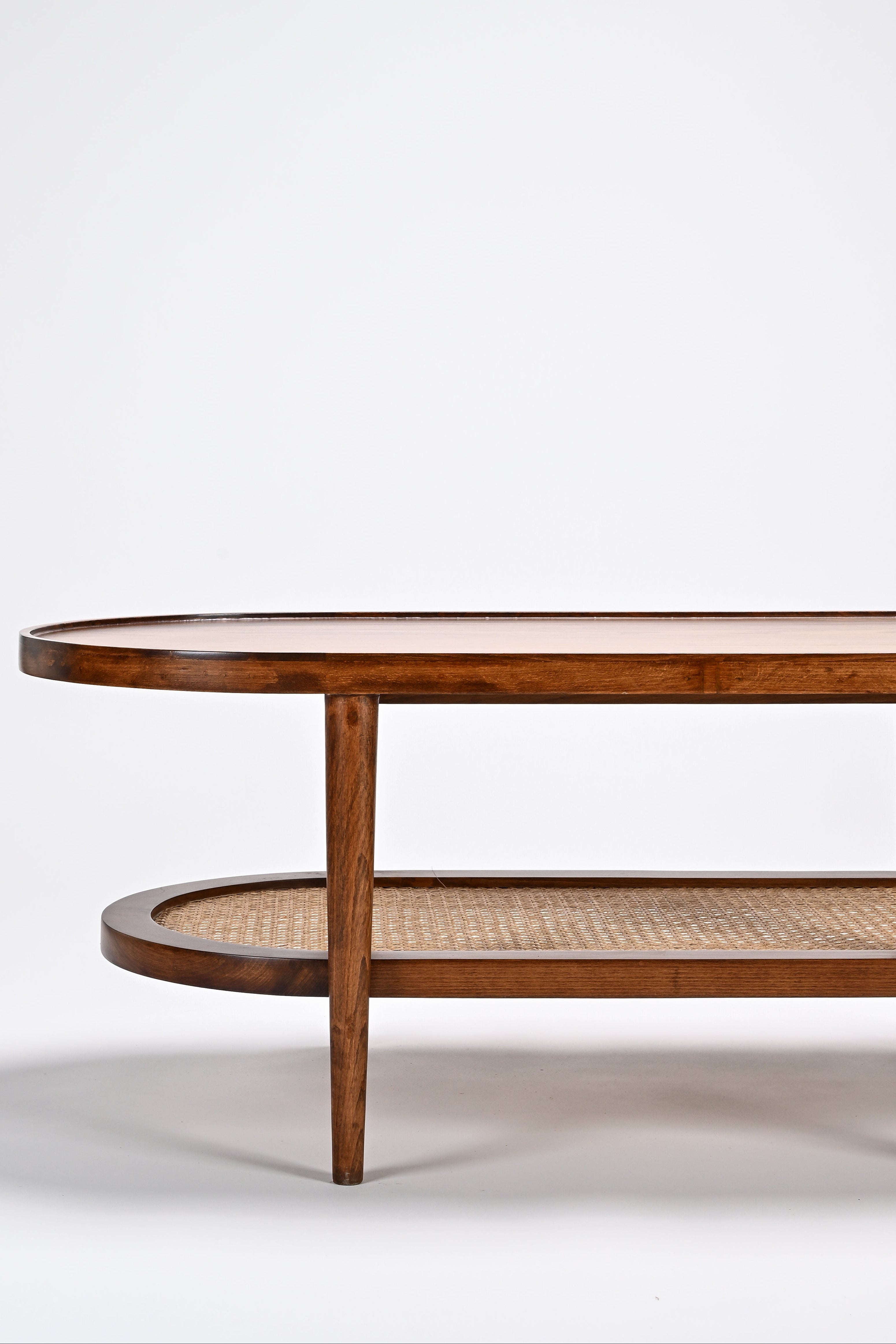 Wooden coffee table with wicker shelf on a white background