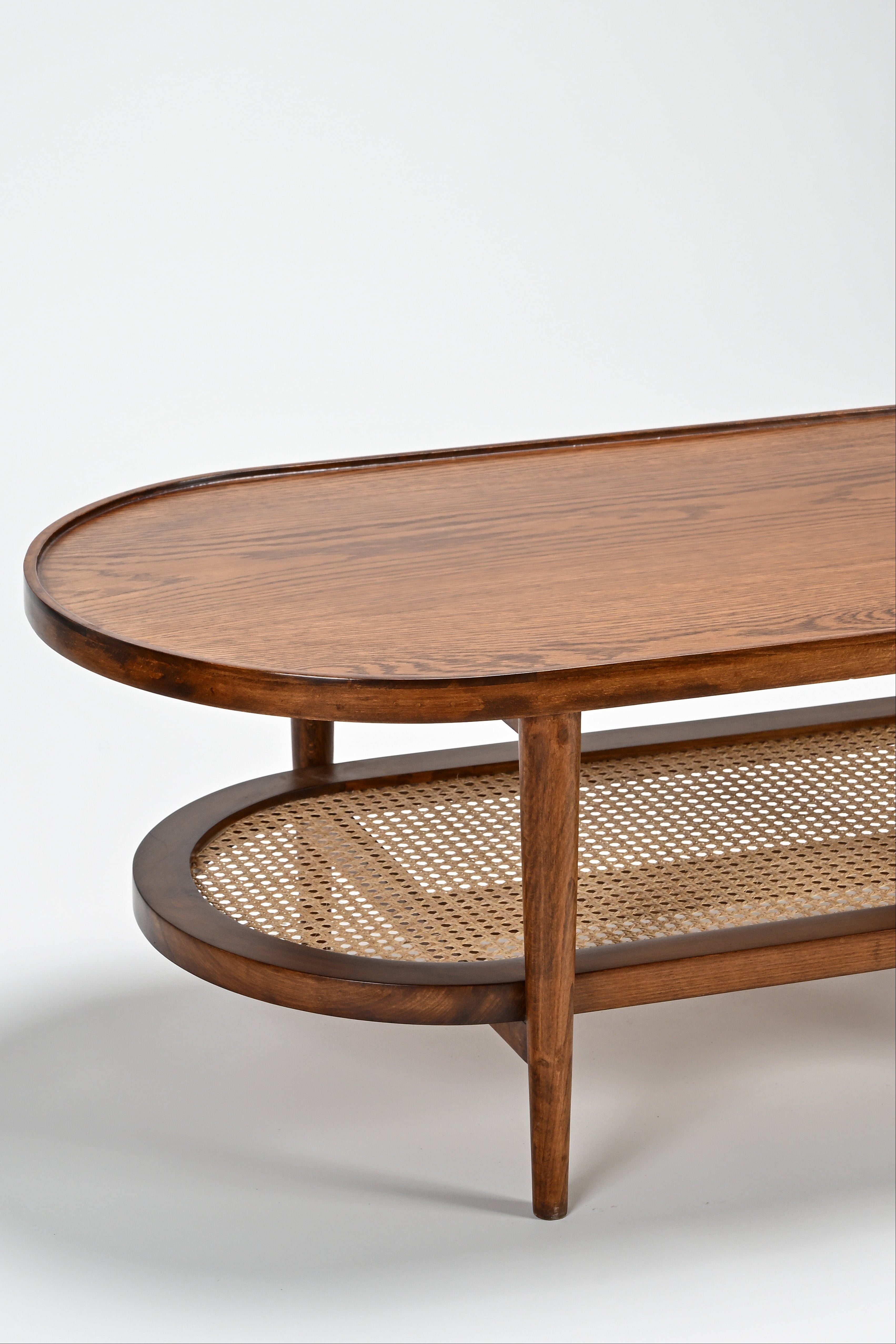 Wooden coffee table with wicker shelf on a white background