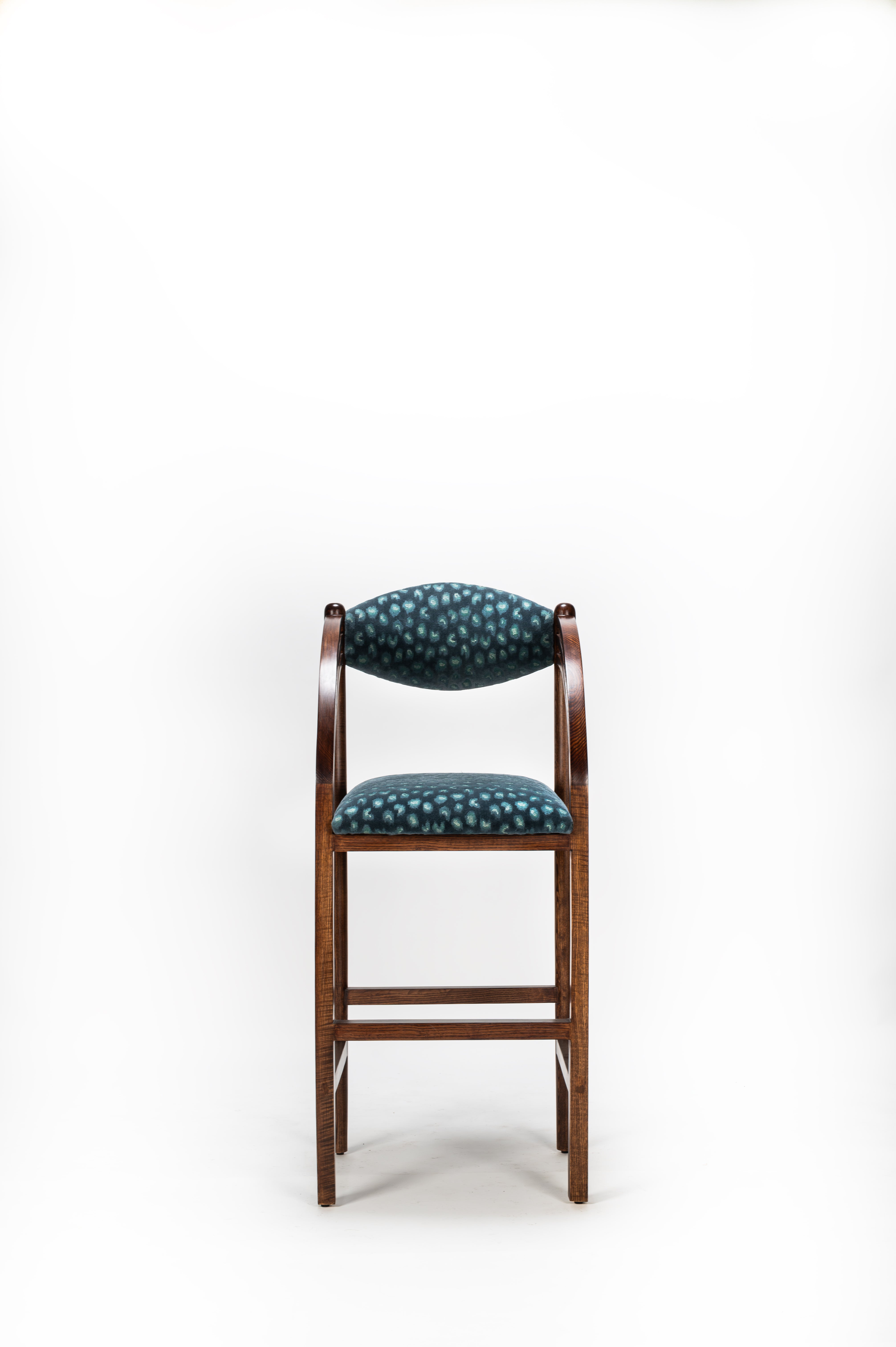 Bar stool with patterned cushion on a white background