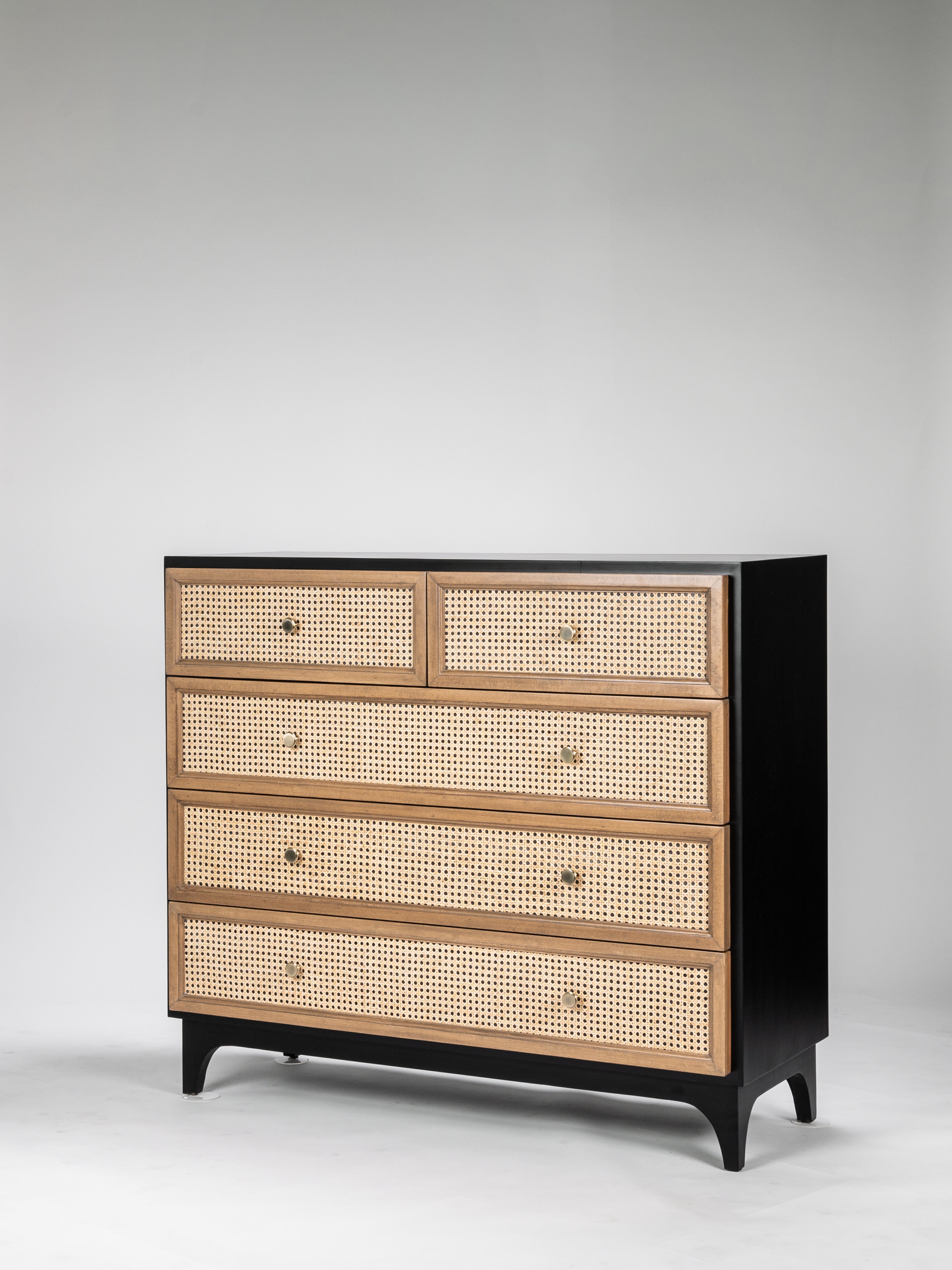 Wooden dresser with cane-patterned drawers on a gray background