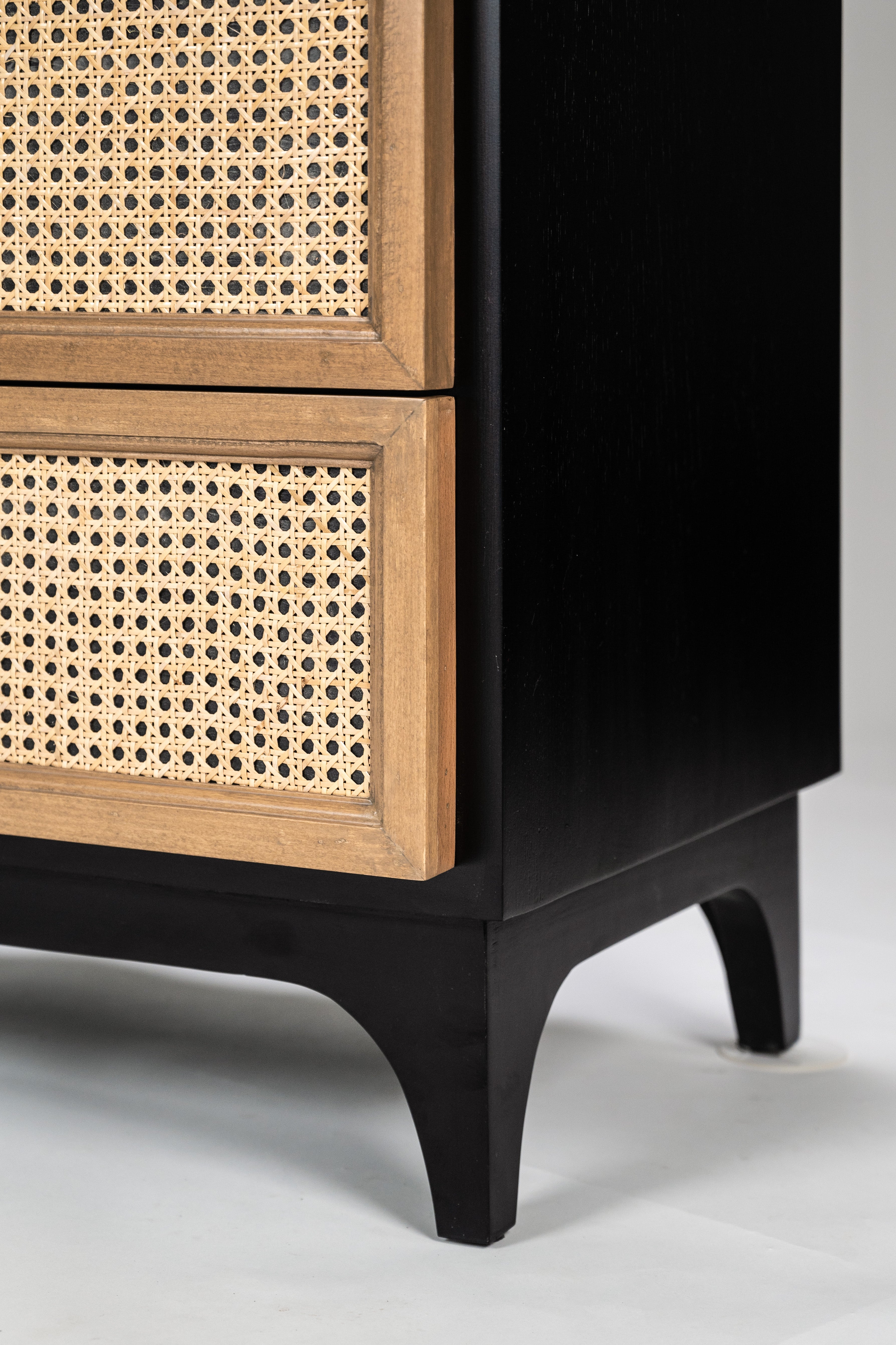 Cabinet with black base and wooden top with woven pattern on a light gray background