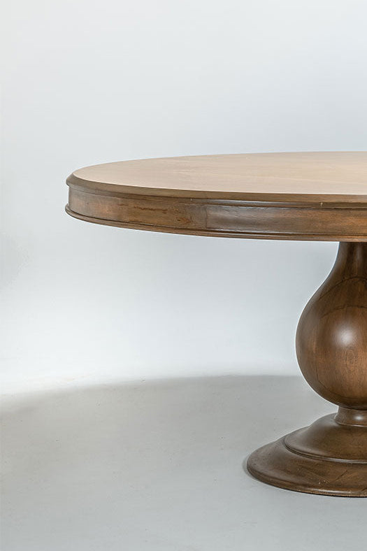 Round wooden table with a pedestal base on a white background