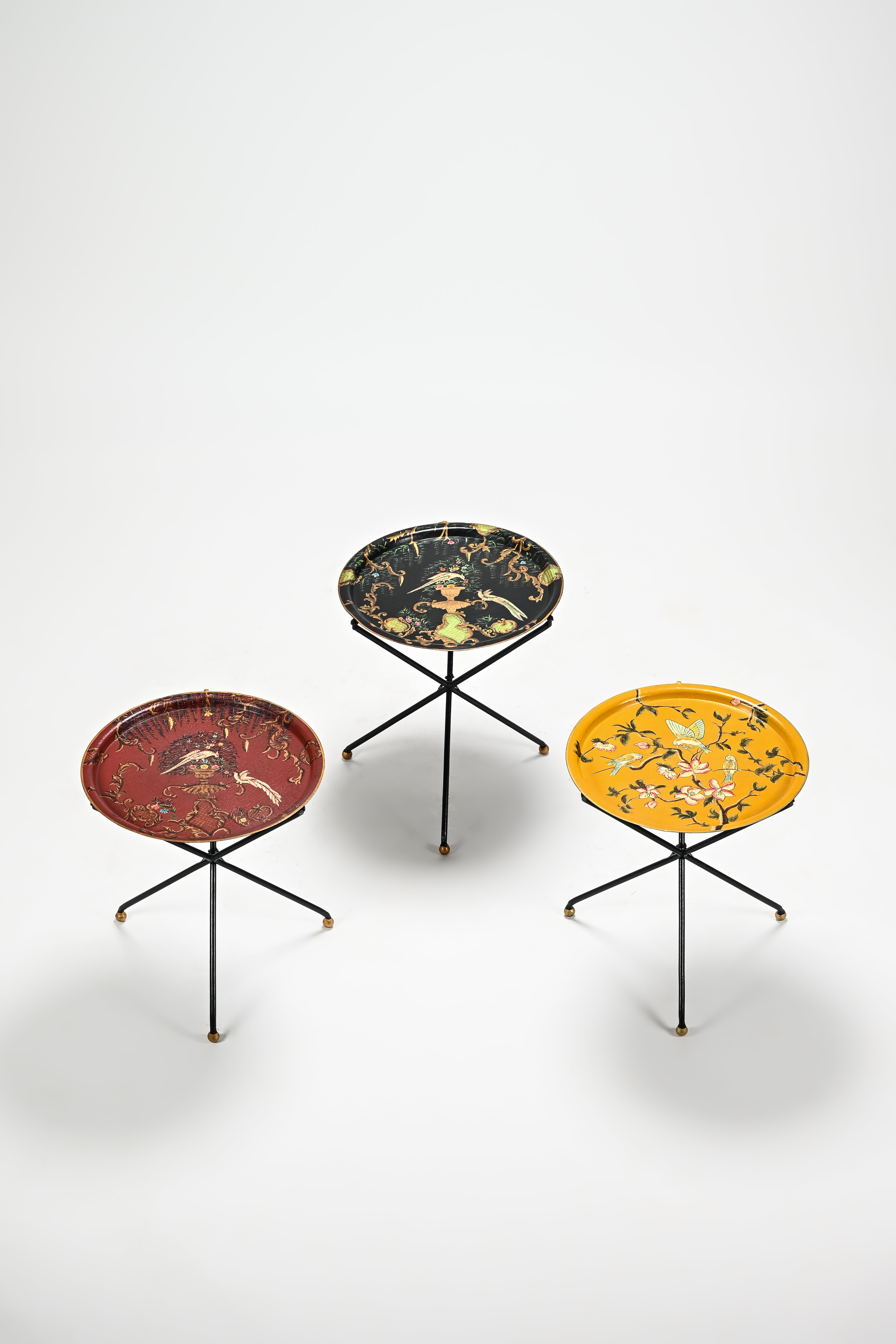 Three decorative side tables with different designs on a white background
