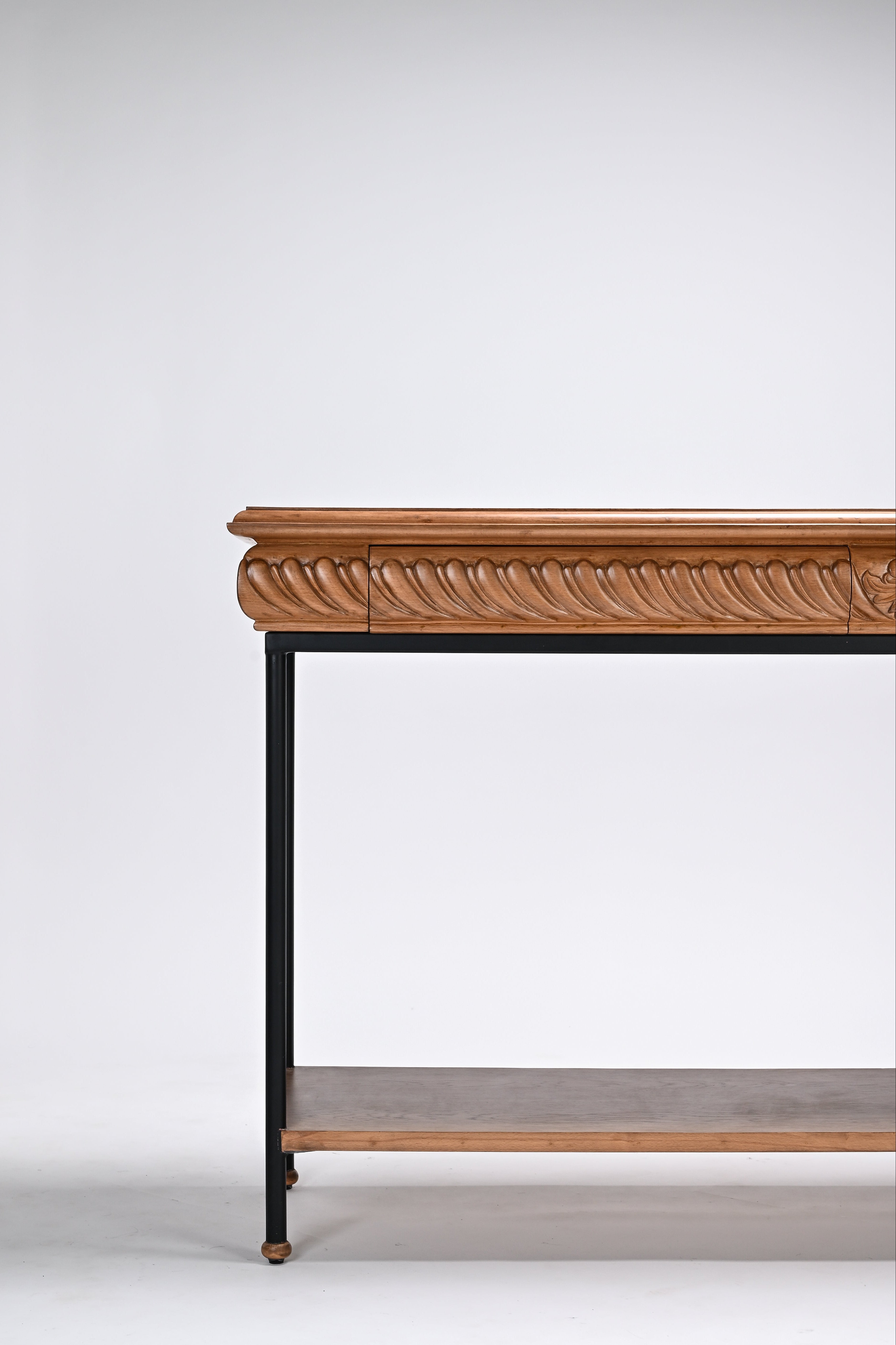 Wooden console table with decorative carvings on a white background