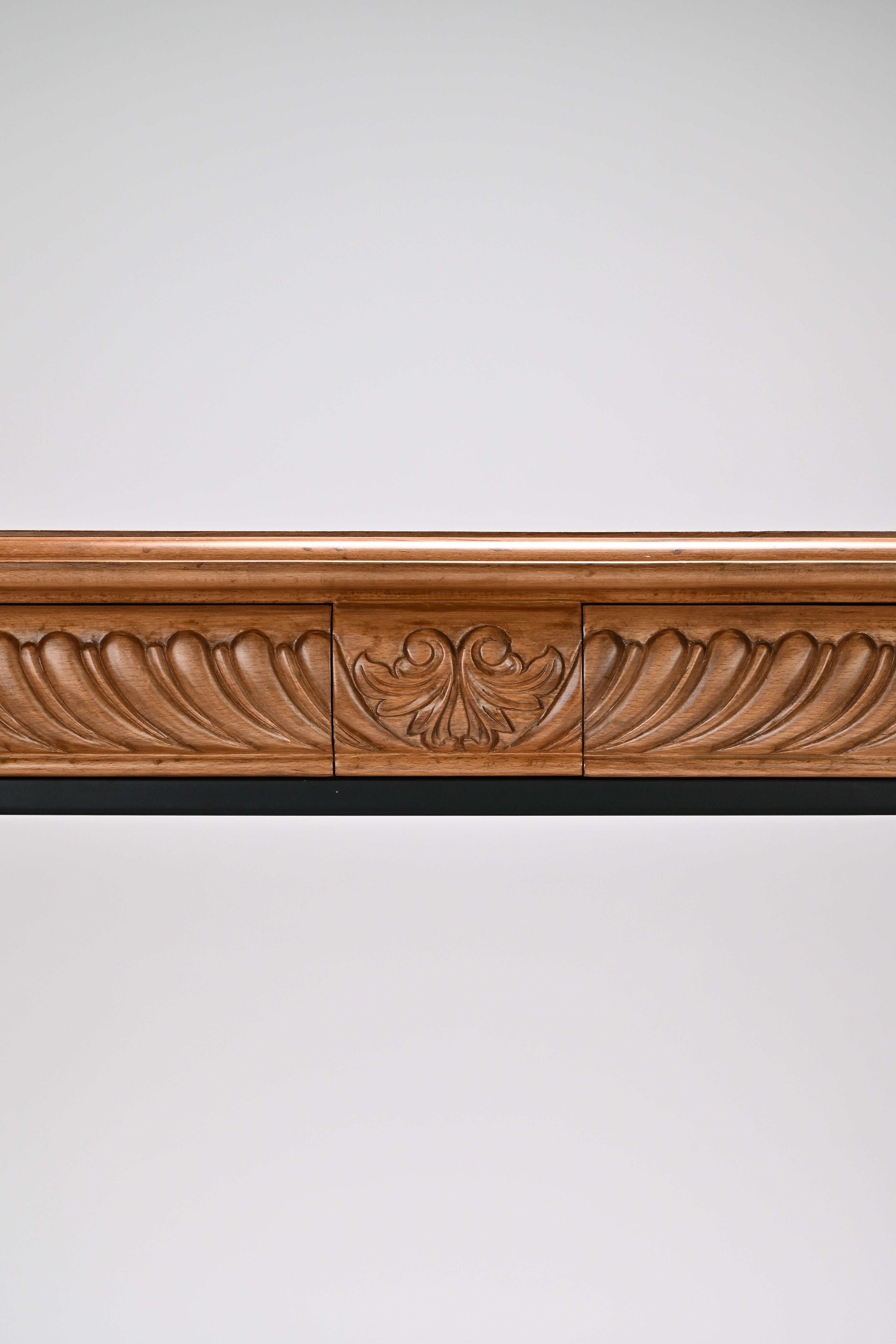 Wooden decorative cornice on a white wall